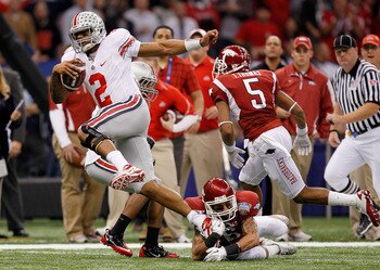 NEW ORLEANS, LA - JANUARY 04:  Terrelle Pryor #2 of the Ohio State Buckeyes runs with the football as he avoids a tackle by Isaac Madison #6 of the Arkansas Razorbacks in the first quarter during the Allstate Sugar Bowl at the Louisiana Superdome on Janua