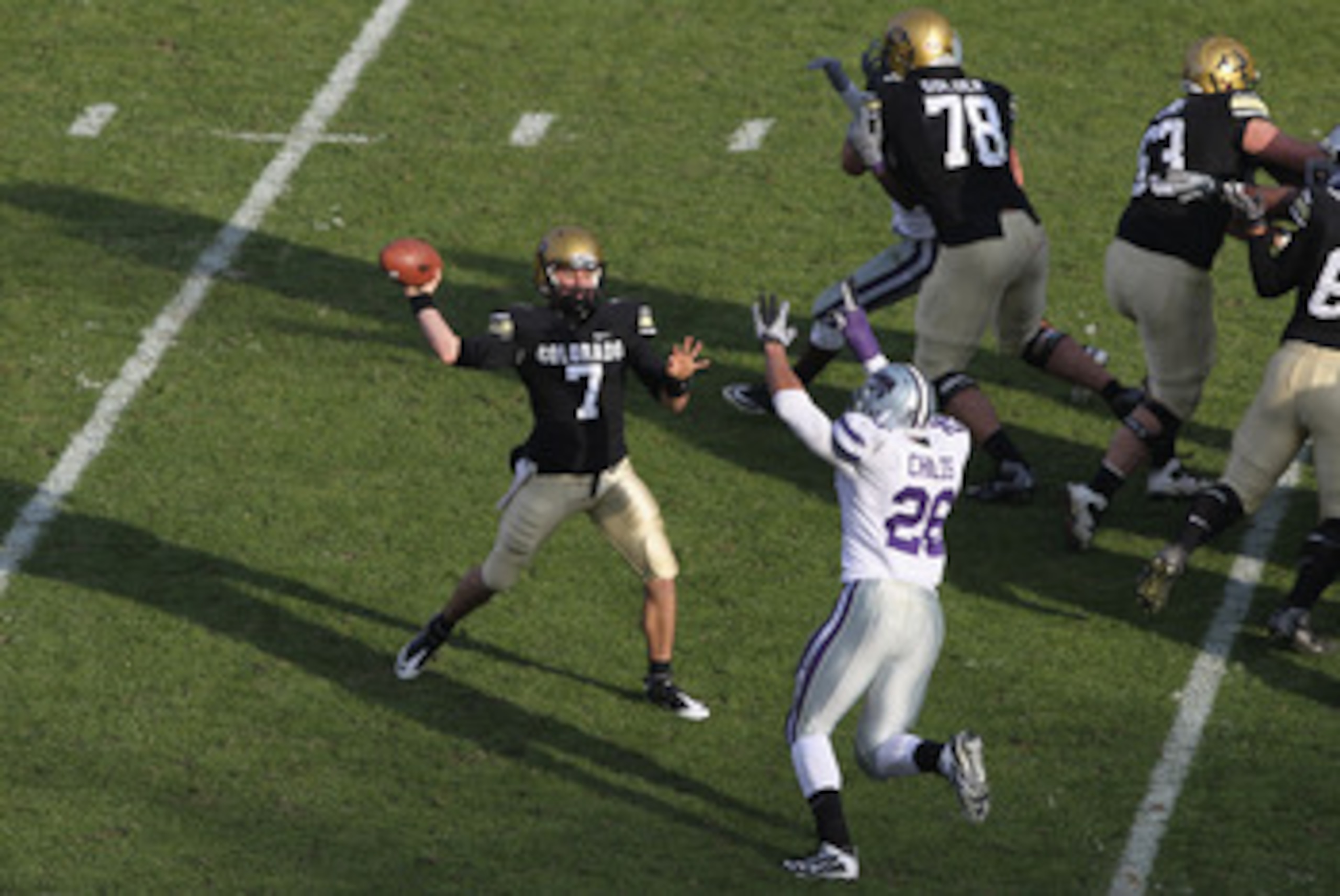 BOULDER, CO - NOVEMBER 20:  Quarterback Cody Hawkins #7 of the Colorado Buffaloes delivers a pass against linebacker Jerrell Childs #26 of the Kansas State Wildcats at Folsom Field on November 20, 2010 in Boulder, Colorado. Colorado defeated Kansas State 