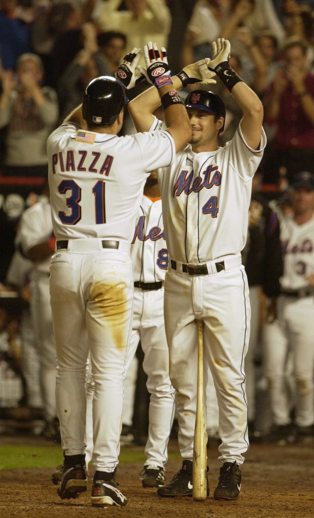 21 Sep 2001:   Robin Ventura #4 of the New York Mets congratulates Mike Piazza #31 after Piazza hit a 2-run home run in the eighth inning of the Mets game against the Atlanta Braves at Shea Stadium in Flushing, New York .  The Mets won 3-2. <DIGITAL IMAGE
