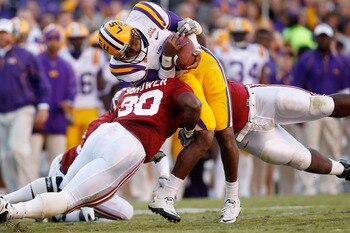 BATON ROUGE, LA - NOVEMBER 06: Quarterback Jordan Jefferson #9 of the Louisiana State University Tigers is tackled by Dont'a Hightower #30 of the Alabama Crimson Tide at Tiger Stadium on November 6, 2010 in Baton Rouge, Louisiana. The Tigers defeated the BATON ROUGE, LA - NOVEMBER 06: Quarterback Jordan Jefferson #9 of the Louisiana State University Tigers is tackled by Dont'a Hightower #30 of the Alabama Crimson Tide at Tiger Stadium on November 6, 2010 in Baton Rouge, Louisiana. The Tigers defeated the