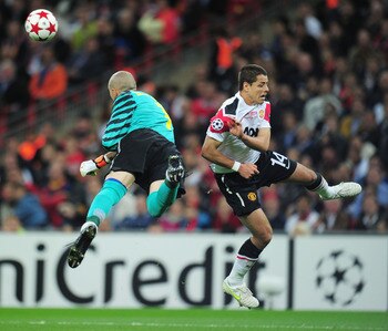 LONDON, ENGLAND - MAY 28:  Victor Valdes of FC Barcelona (L) punches the ball clear from Javier Hernandez of Manchester United during the UEFA Champions League final between FC Barcelona and Manchester United FC at Wembley Stadium on May 28, 2011 in Londo