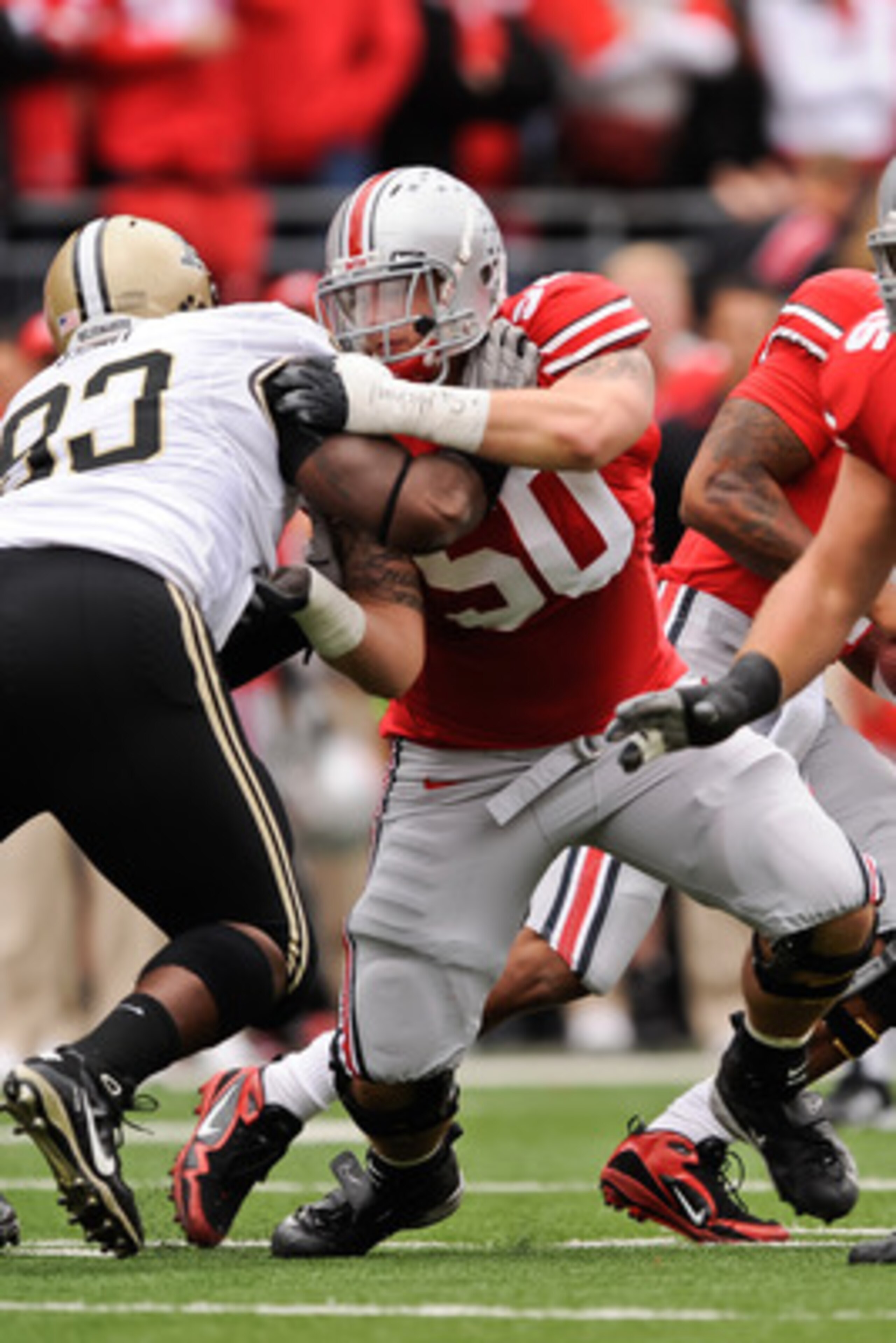 COLUMBUS, OH - OCTOBER 23:  Michael Brewster #50 of the Ohio State Buckeyes blocks against the Purdue Boilermakers at Ohio Stadium on October 23, 2010 in Columbus, Ohio.  (Photo by Jamie Sabau/Getty Images)