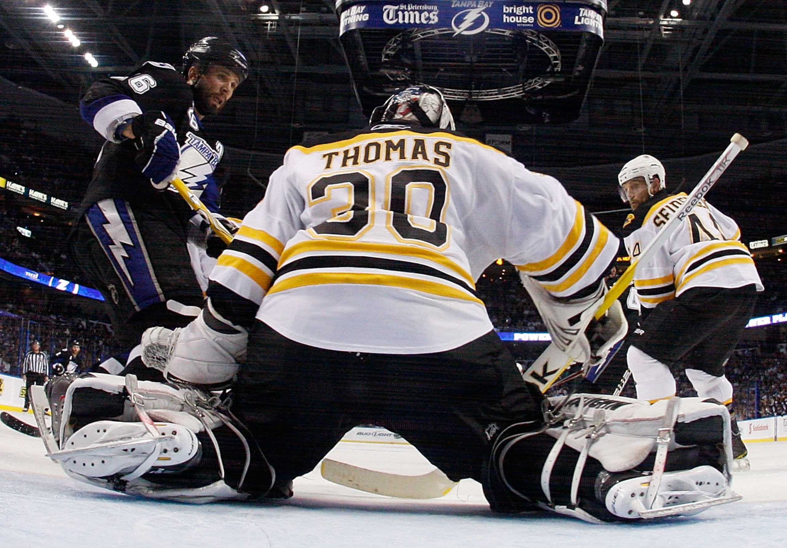 TAMPA, FL - MAY 25:  Dennis Seidenberg #44 and Tim Thomas #30 of the Boston Bruins defend against Martin St. Louis #26 of the Tampa Bay Lightning in Game Six of the Eastern Conference Finals during the 2011 NHL Stanley Cup Playoffs at St Pete Times Forum