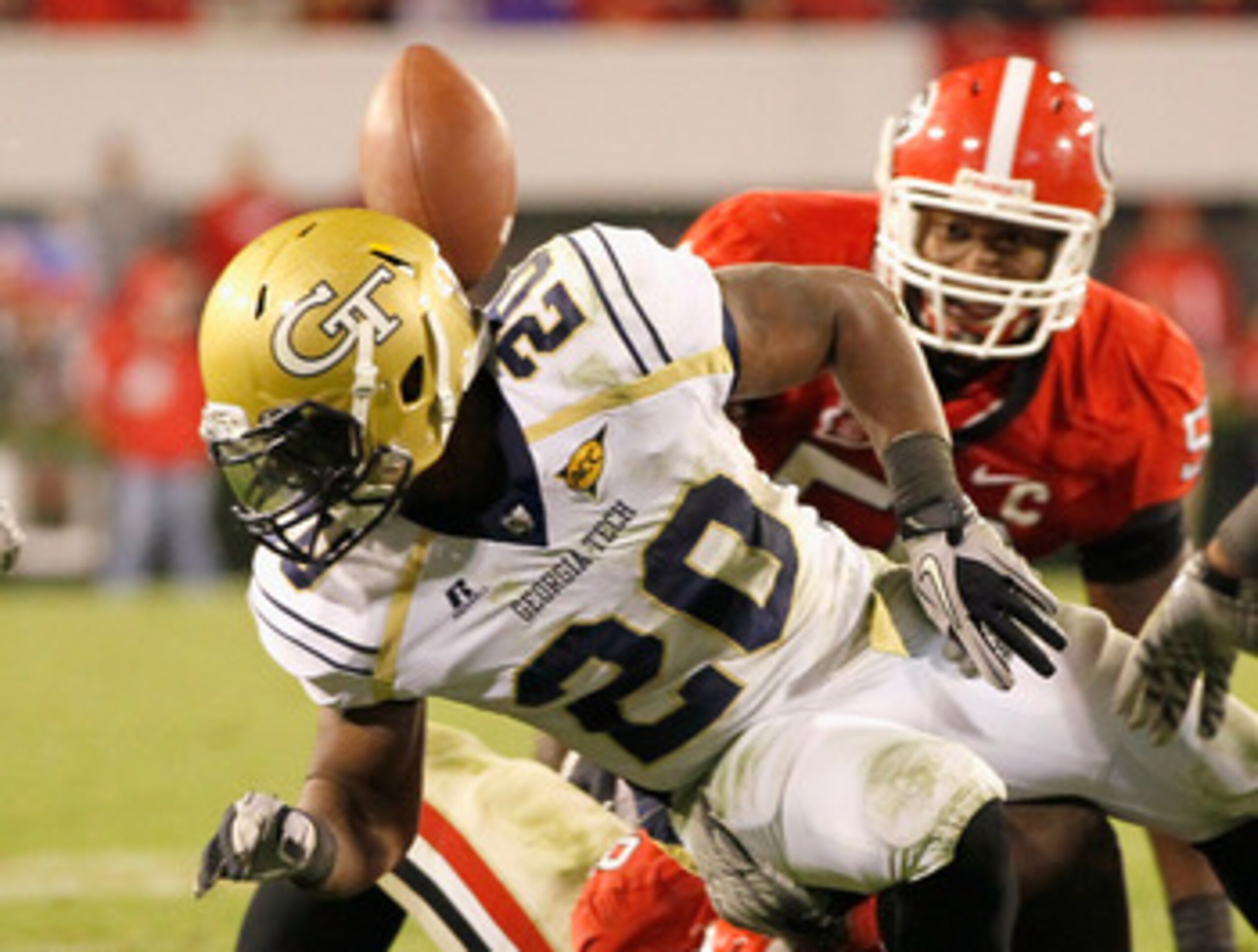 ATHENS, GA - NOVEMBER 27:  Roddy Jones #20 of the Georgia Tech Yellow Jackets has the ball stripped behind him by the Georgia Bulldogs at Sanford Stadium on November 27, 2010 in Athens, Georgia.  (Photo by Kevin C. Cox/Getty Images)