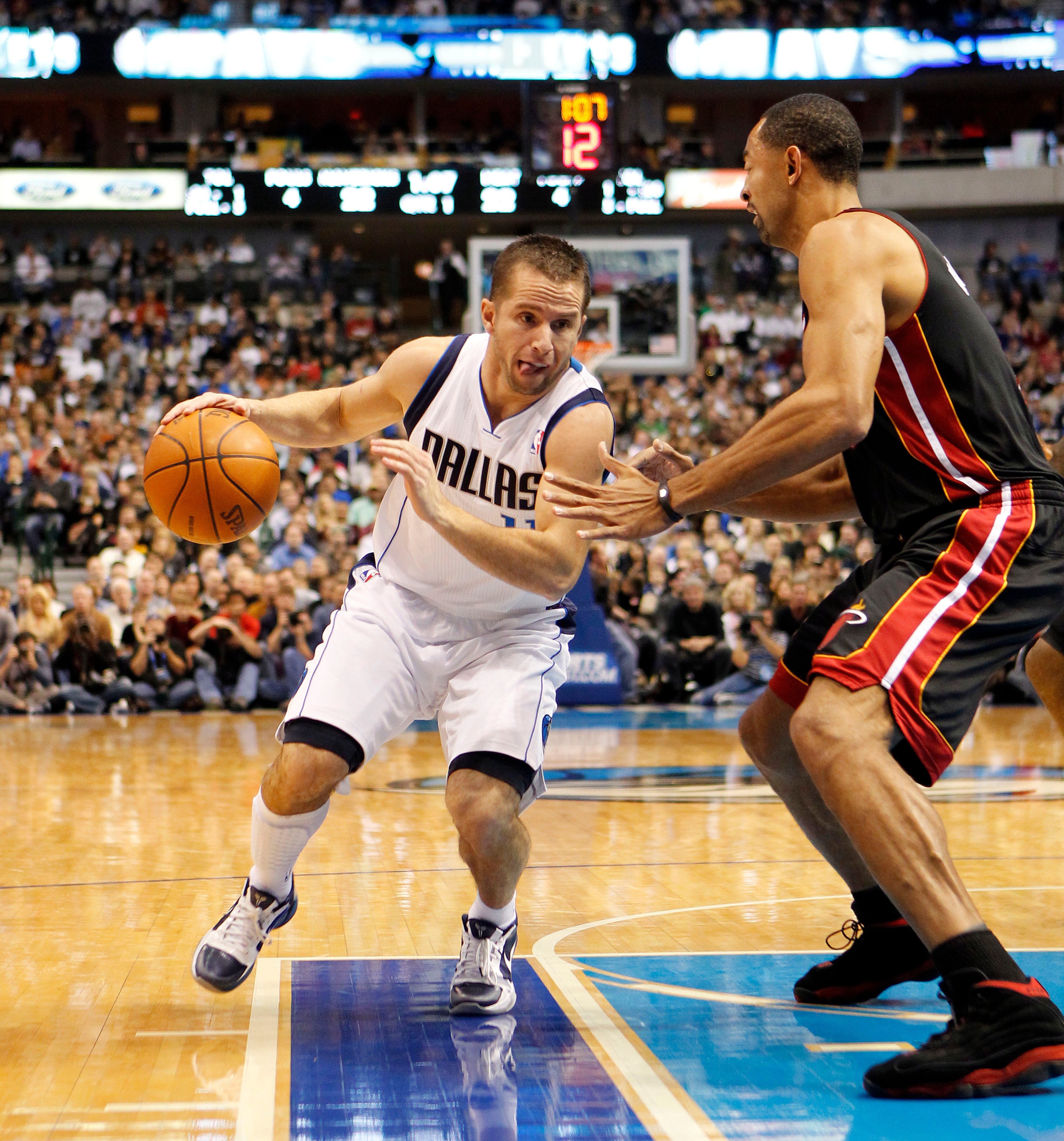 DALLAS - NOVEMBER 27: Jose Barea #11 of the Dallas Mavericks drives by Juwan Howard #5 of the Miami Heat on November 27, 2010 at the American Airlines Center in Dallas, Texas. NOTE TO USER: User expressly acknowledges and agrees that, by downloading and o DALLAS - NOVEMBER 27: Jose Barea #11 of the Dallas Mavericks drives by Juwan Howard #5 of the Miami Heat on November 27, 2010 at the American Airlines Center in Dallas, Texas. NOTE TO USER: User expressly acknowledges and agrees that, by downloading and o