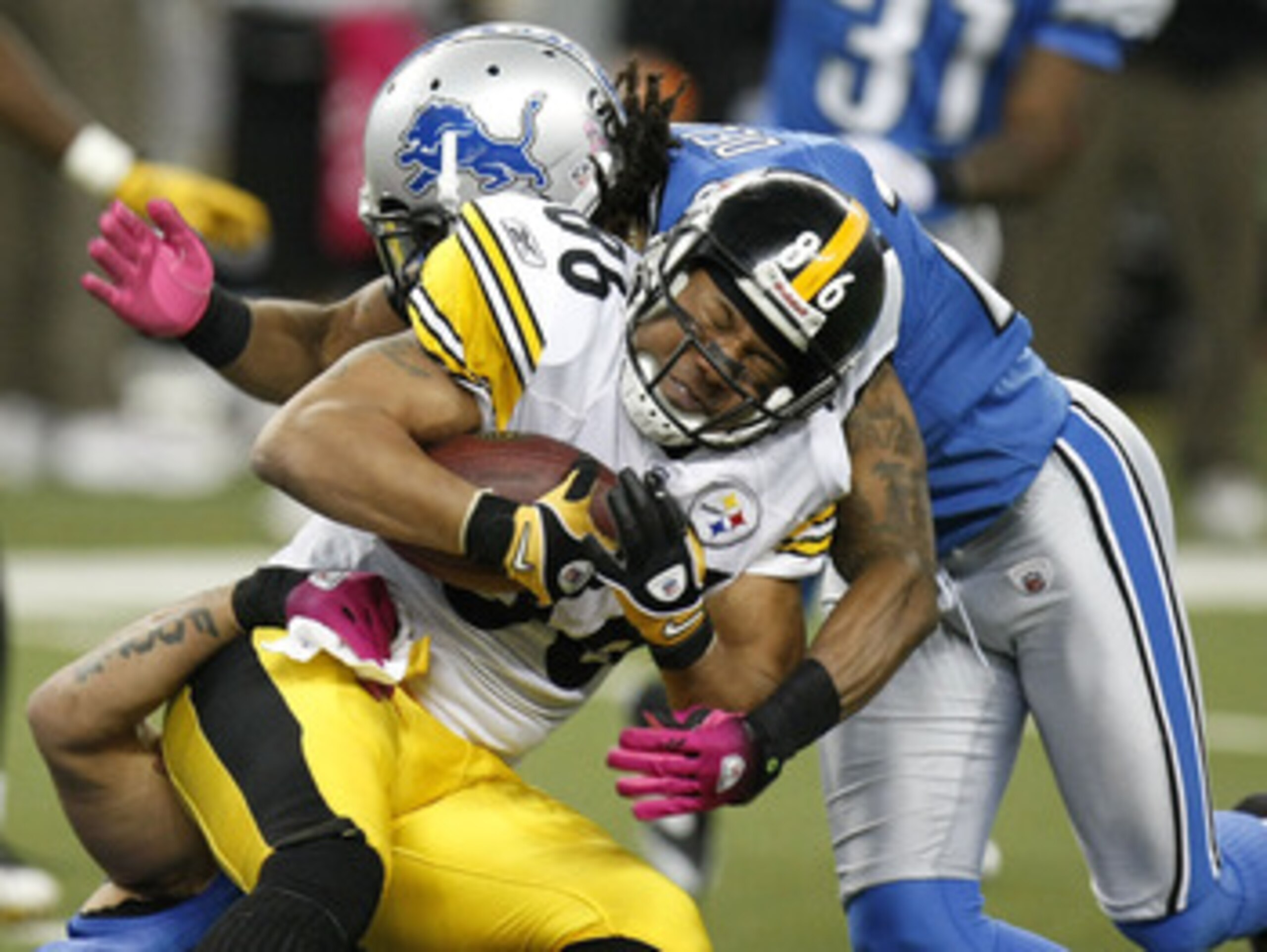 DETROIT , MI - OCTOBER 11:  Hines Ward #86 of the Pittsburgh Steelers is tackled after a fourth quarter catch by Louis Delmas #26 of the Detroit Lions on October 11, 2009 at Ford Field in Detroit, Michigan. Pittsburgh won the game 28-20.(Photo by Gregory 