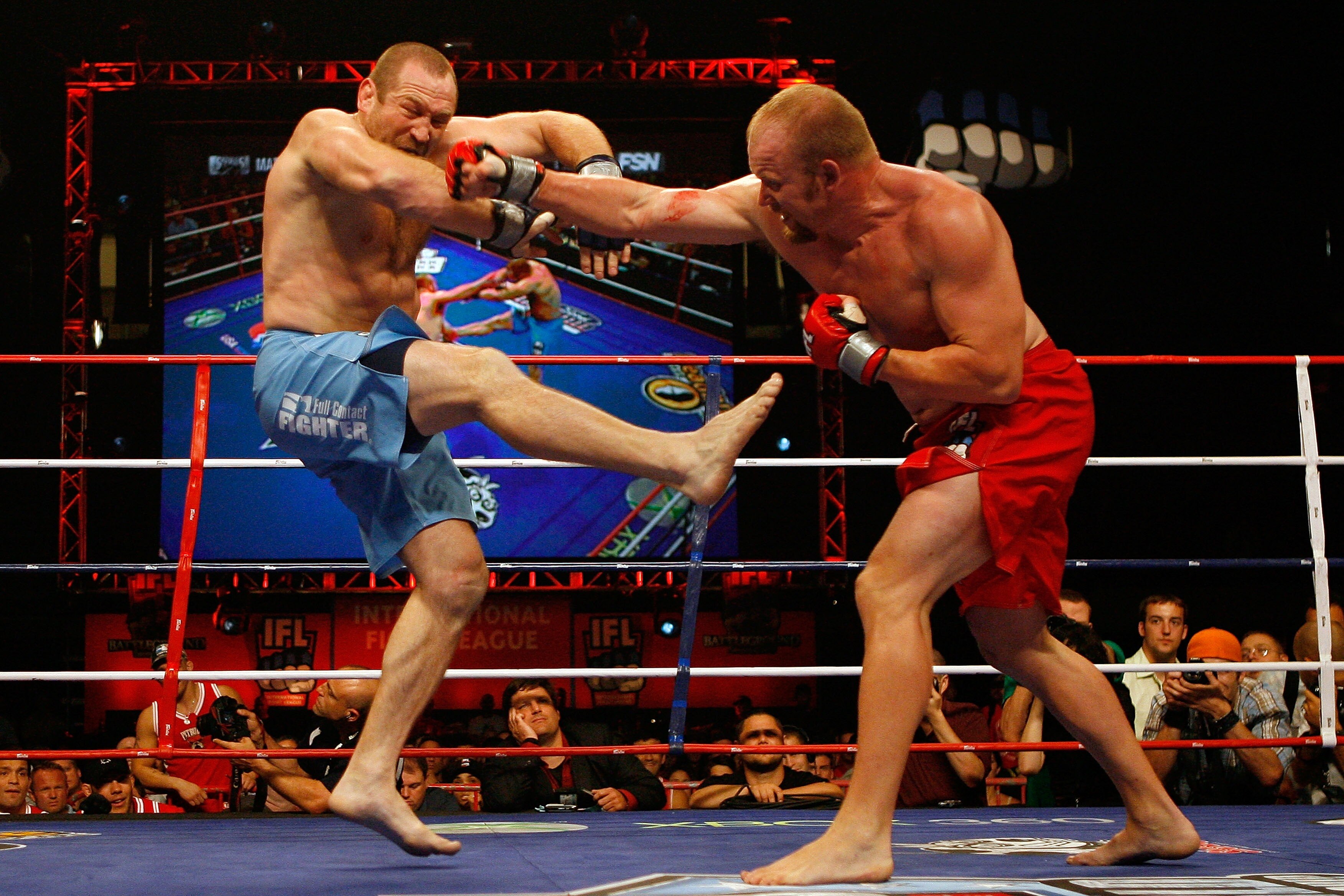 EAST RUTHERFORD, NJ - AUGUST 02:  Vladimir Matyushenko (blue) of the Tokyo Sabres fiights against Tim Boetsch of the New York Pitbulls during the IFL semifinals at the Continental Airlines Arena on August 2, 2007 in East Rutherford, New Jersey.  (Photo by