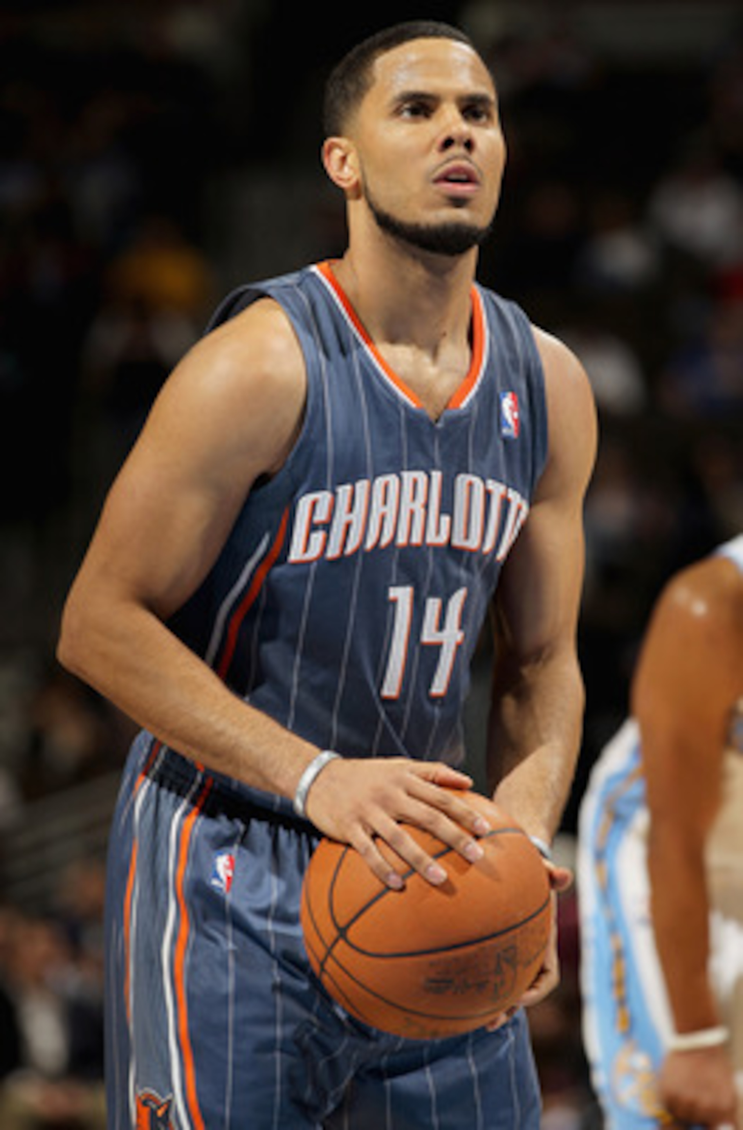 DENVER, CO - MARCH 02:  D.J. Augustin #14 of the Charlotte Bobcats takes a free throw against the Denver Nuggets at the Pepsi Center on March 2, 2011 in Denver, Colorado. The Nuggets defeated the Bobcats 120-80.NOTE TO USER: User expressly acknowledges an