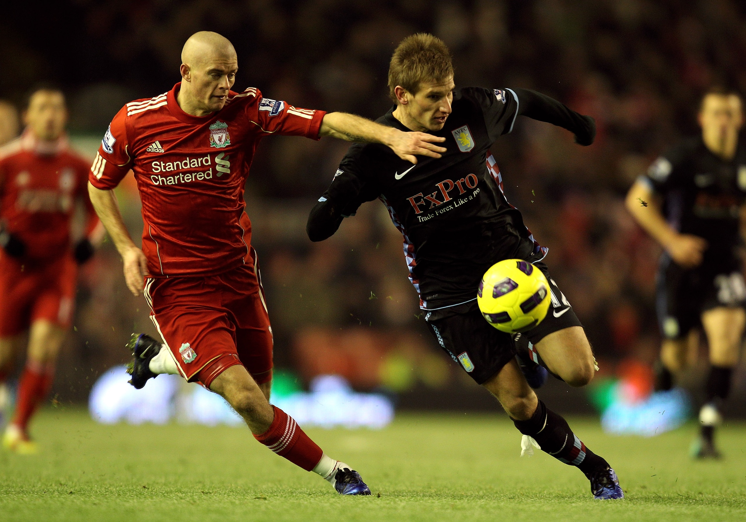 LIVERPOOL, ENGLAND - DECEMBER 06:   Marc Albrighton of Aston Villa is challenged by Paul Konchesky of Liverpool during the Barclays Premier League match between Liverpool and Aston Villa at Anfield on December 6, 2010 in Liverpool, England. (Photo by Mark