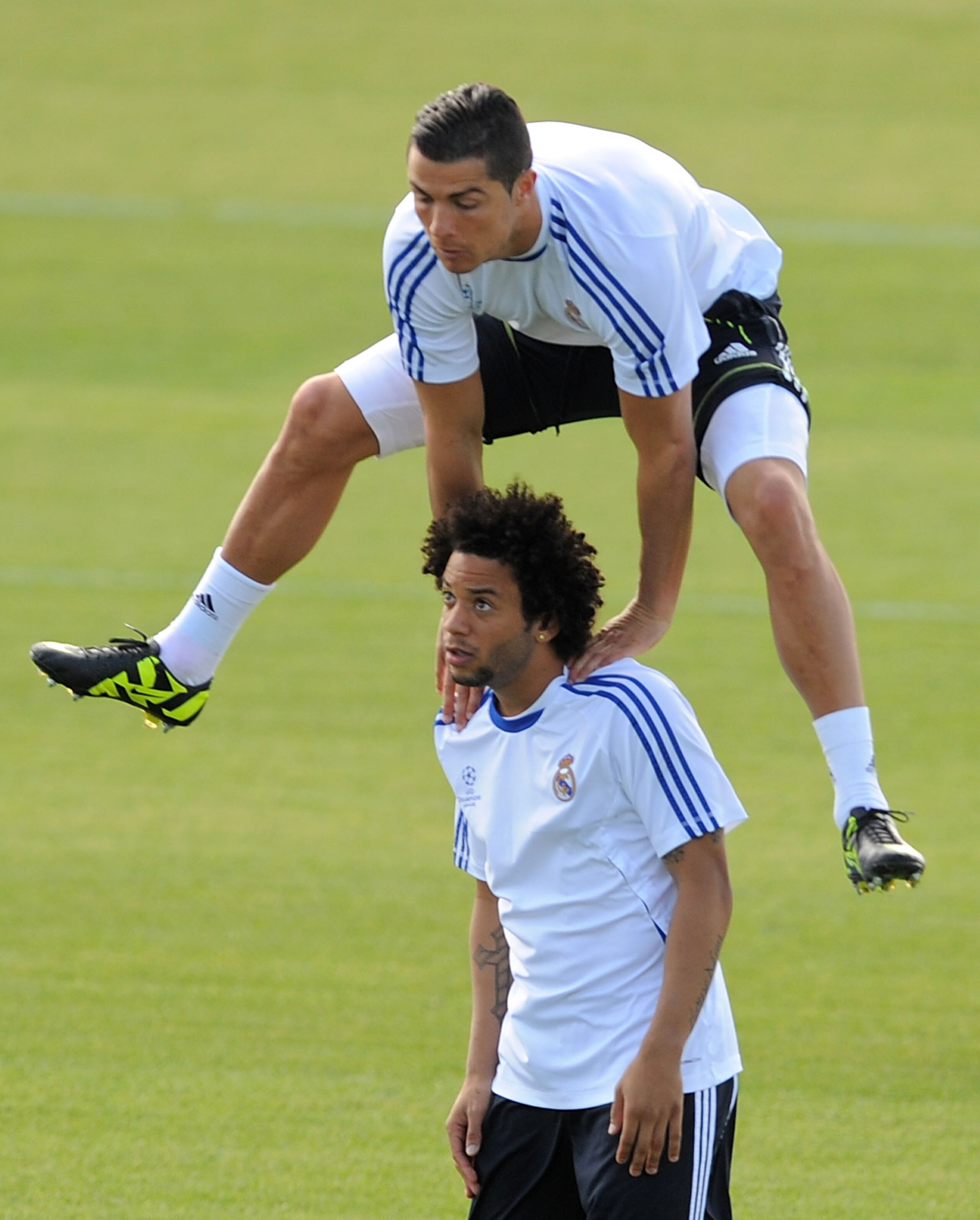 MADRID, SPAIN - APRIL 26:  Cristiano Ronaldo of Real Madrid jumps over Marcelo during a training session at Valdebebas training ground ahead of their UEFA Champions League semi-final first leg match against Barcelona on April 26, 2011 in Madrid, Spain  (P