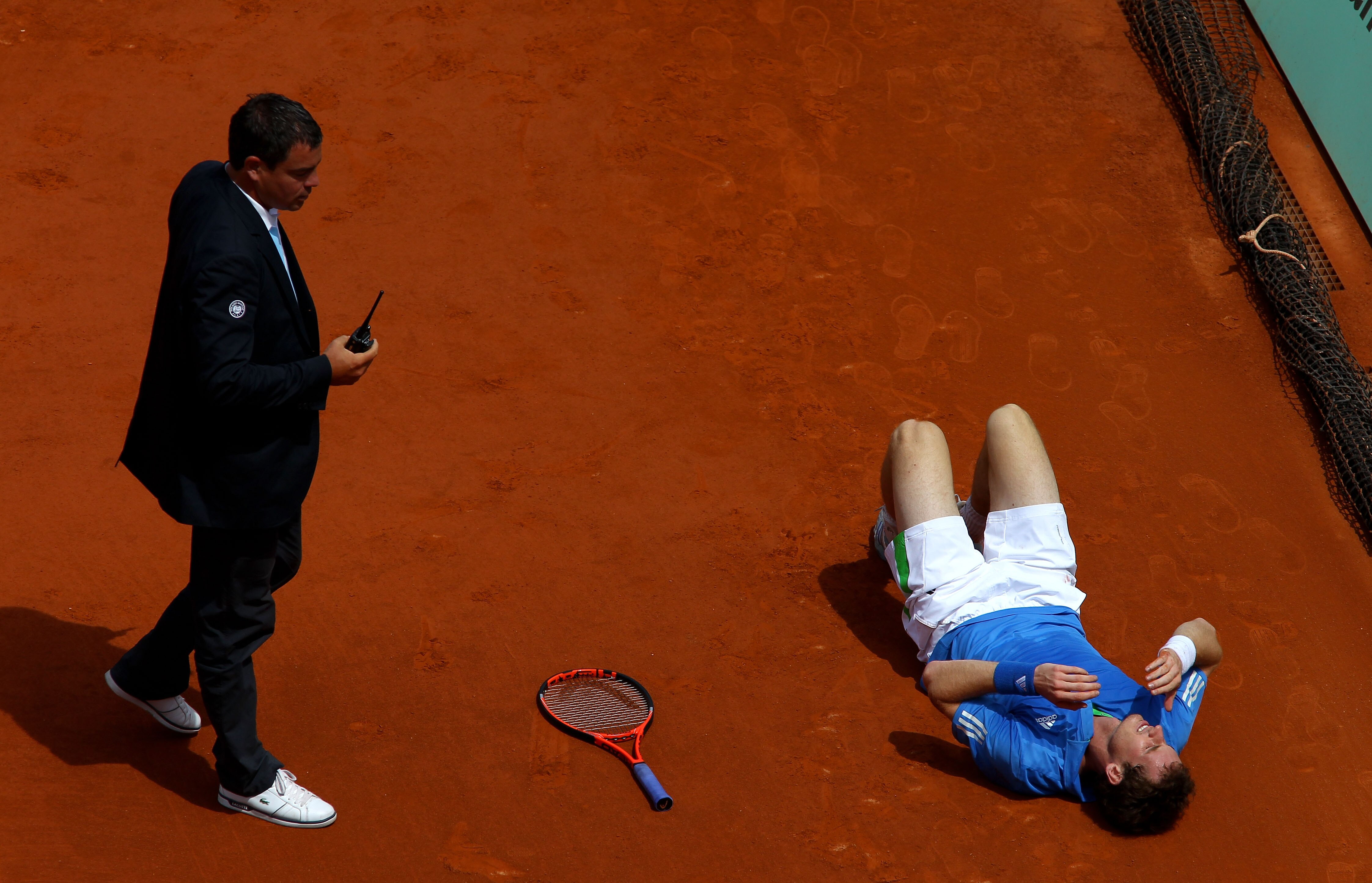 PARIS, FRANCE - MAY 28:  Andy Murray of Great Britain grimaces as lies on the court after injuring his foot during the men's singles round three match between Andy Murray of Great Britain and Michael Berrer of Germany on day seven of the French Open at Ro