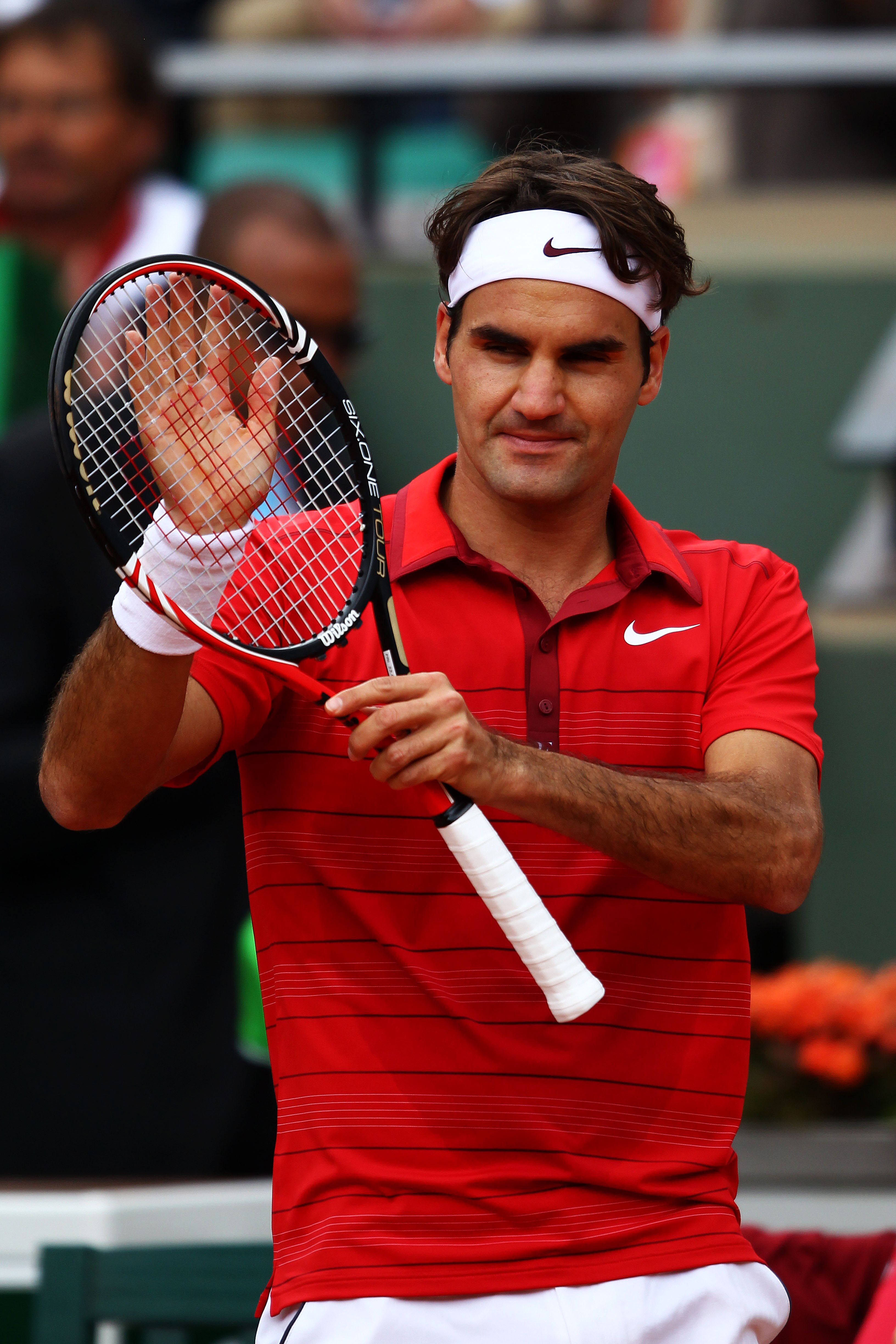 PARIS, FRANCE - MAY 27:  Roger Federer of Switzerland applauds the crowd as he celebrates match point during the men's singles round three match between Janko Tipsarevic of Serbia and Roger Federer of Switzerland on day six of the French Open at Roland Ga