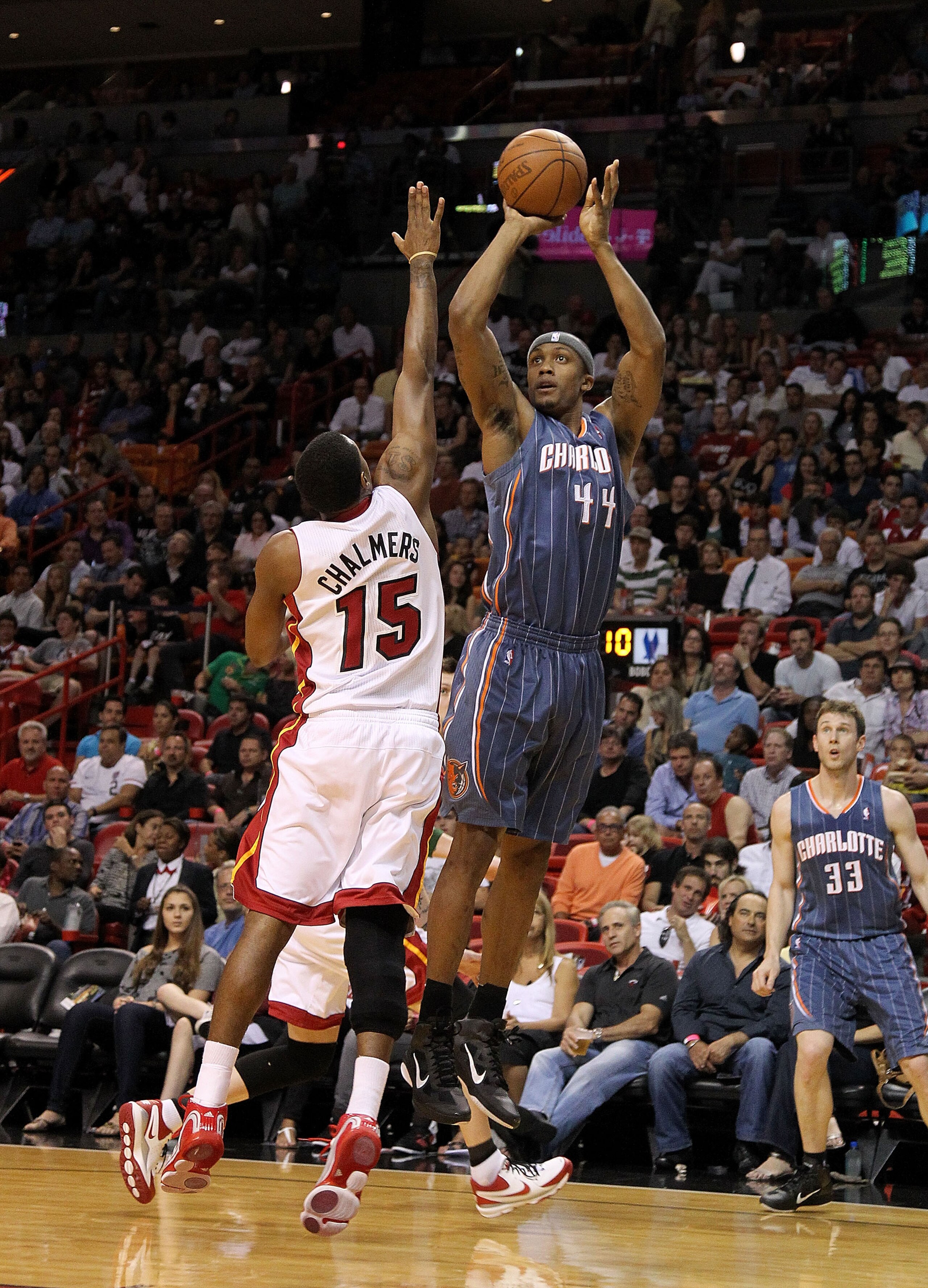 MIAMI, FL - APRIL 08:  Dante Cunningham #44 of the Charlotte Bobcats shoots over Mario Chalmers #15 of the Miami Heat during a game at American Airlines Arena on April 8, 2011 in Miami, Florida. NOTE TO USER: User expressly acknowledges and agrees that, b