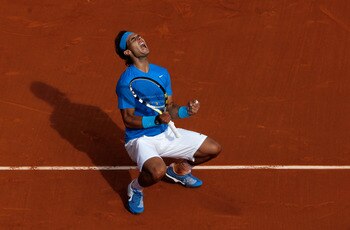 PARIS, FRANCE - MAY 24:  Rafael Nadal of Spain celebrates match point during the men's singles round one match between Rafael Nadal of Spain and John Isner of USA on day three of the French Open at Roland Garros on May 24, 2011 in Paris, France.  (Photo b