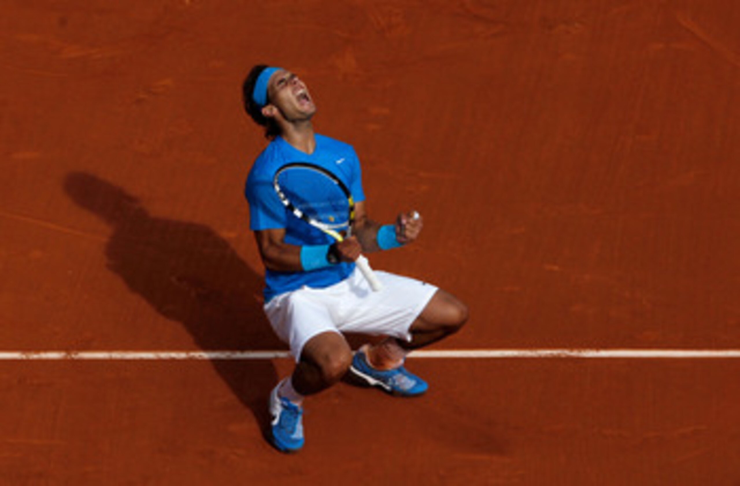 PARIS, FRANCE - MAY 24:  Rafael Nadal of Spain celebrates match point during the men's singles round one match between Rafael Nadal of Spain and John Isner of USA on day three of the French Open at Roland Garros on May 24, 2011 in Paris, France.  (Photo b