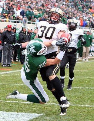 EAST LANSING, MI - NOVEMBER 08:  Joe Holland #30 of the Purdue Boilermakers breaks up a pass in the endzone by Blair White #25 of the Michigan State Spartans at Spartan Stadium on November 8, 2008 in East Lansing, Michigan.  (Photo by Jim McIsaac/Getty Im