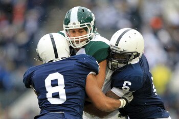 STATE COLLEGE, PA - NOVEMBER 27: Tight end Brian Linthicum #88 of the Michigan State Spartans is tackled by cornerback D'Anton Lynn #8 and linebacker Gerald Hodges #6 of the Penn State Nittany Lions during a game on November 27, 2010 at Beaver Stadium in