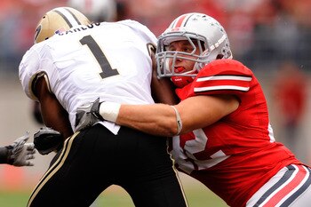 COLUMBUS, OH - OCTOBER 23:  Running back Keith Carlos #1 of the Purdue Boilermakers is tackled by Andrew Sweat #42 of the Ohio State Buckeyes at Ohio Stadium on October 23, 2010 in Columbus, Ohio.  (Photo by Jamie Sabau/Getty Images)
