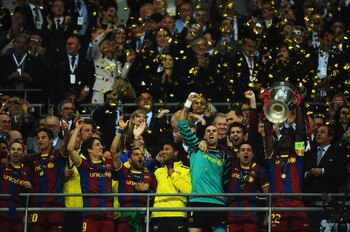 LONDON, ENGLAND - MAY 28:  Eric Abidal (R) of FC Barcelona lifts the trophy and celebrates with teammates after victory in the UEFA Champions League final between FC Barcelona and Manchester United FC at Wembley Stadium on May 28, 2011 in London, England.