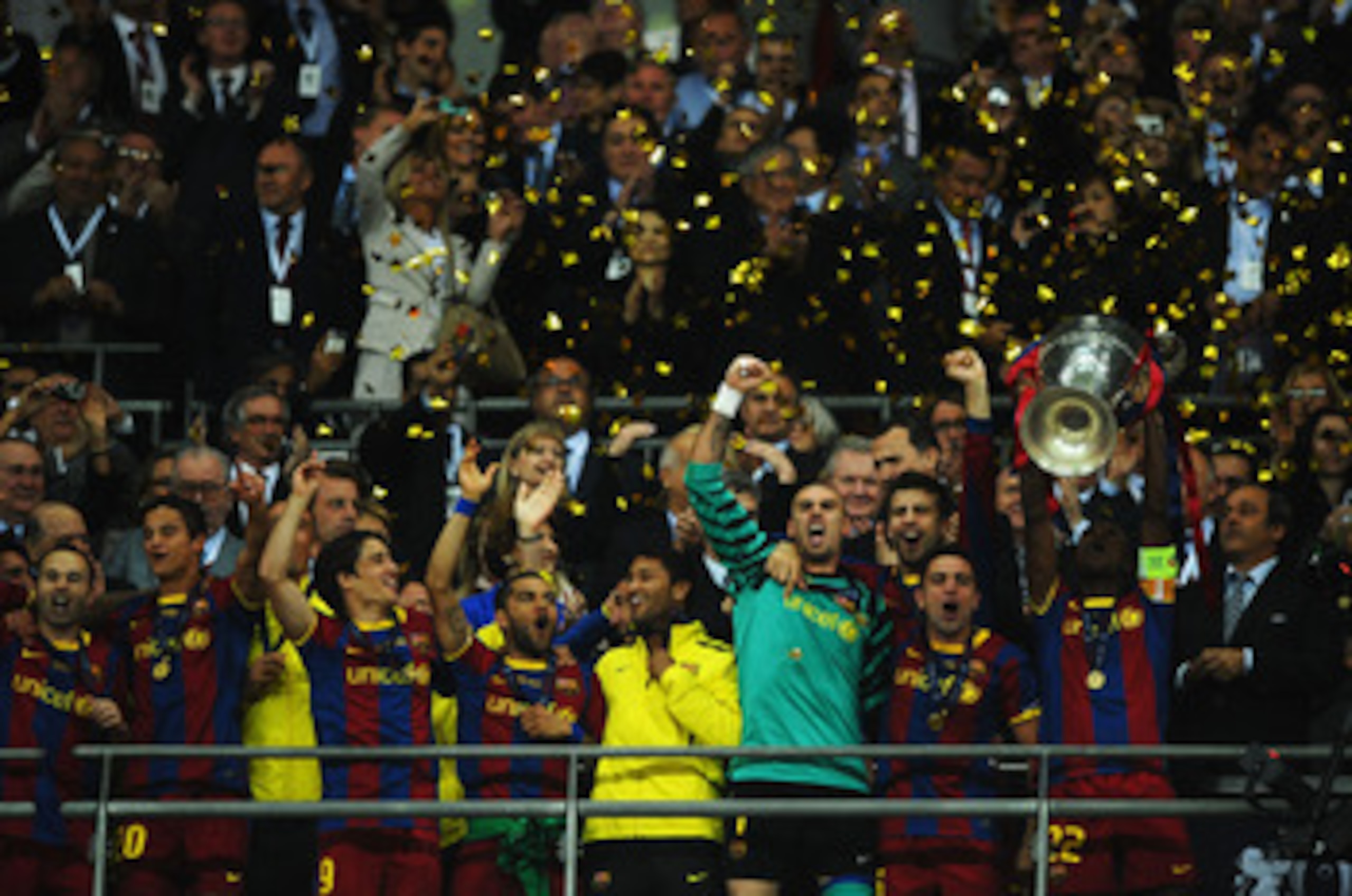 LONDON, ENGLAND - MAY 28:  Eric Abidal (R) of FC Barcelona lifts the trophy and celebrates with teammates after victory in the UEFA Champions League final between FC Barcelona and Manchester United FC at Wembley Stadium on May 28, 2011 in London, England.