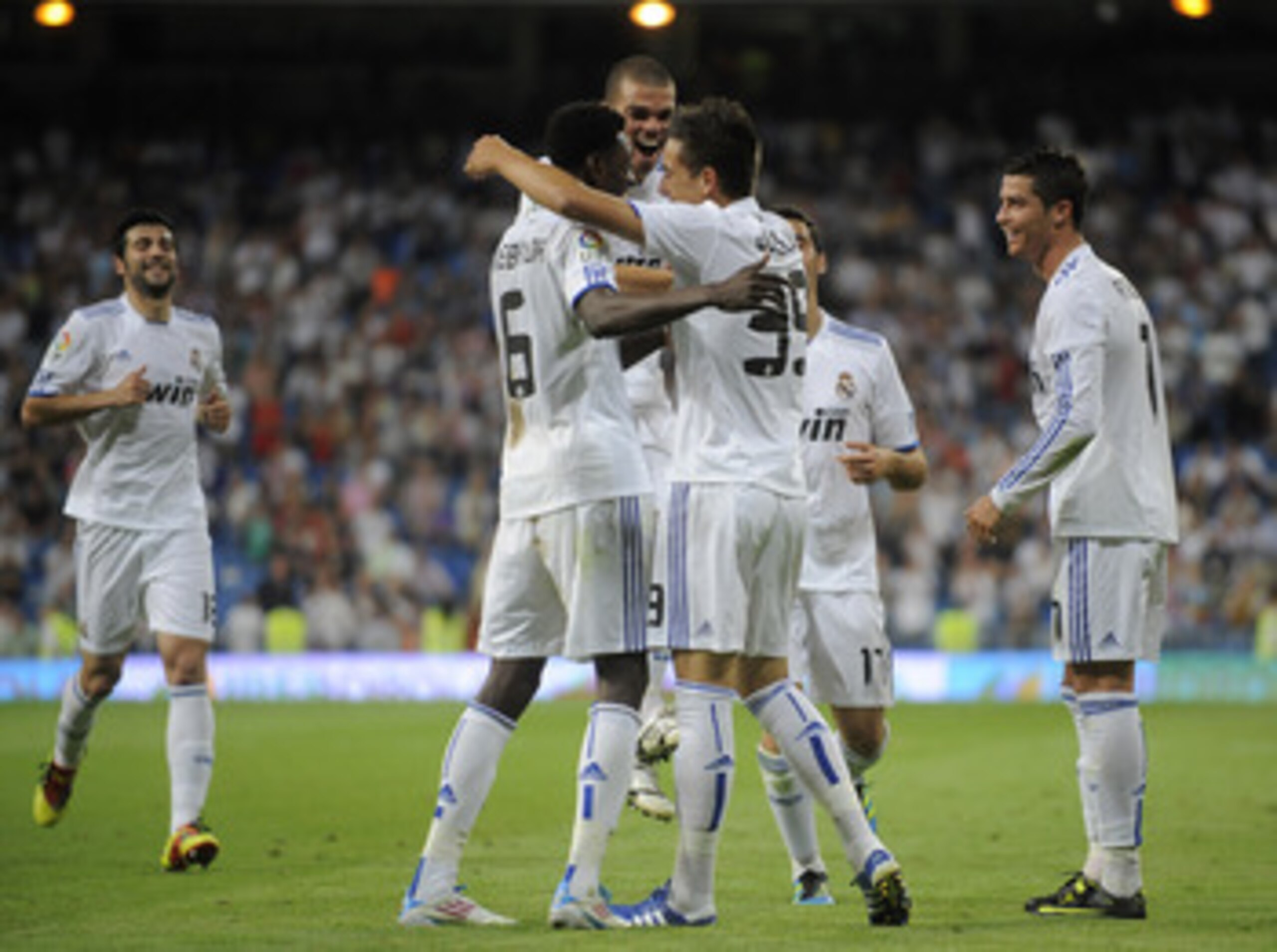 MADRID, SPAIN - MAY 21:  Joselu (R) of Real Madrid celebrates with Emmanuel Adebayor (L) and Cristiano Ronaldo after scoring Real's 8th goal during the La Liga match between Real Madrid and UD Almeria at Estadio Santiago Bernabeu on May 21, 2011 in Madrid