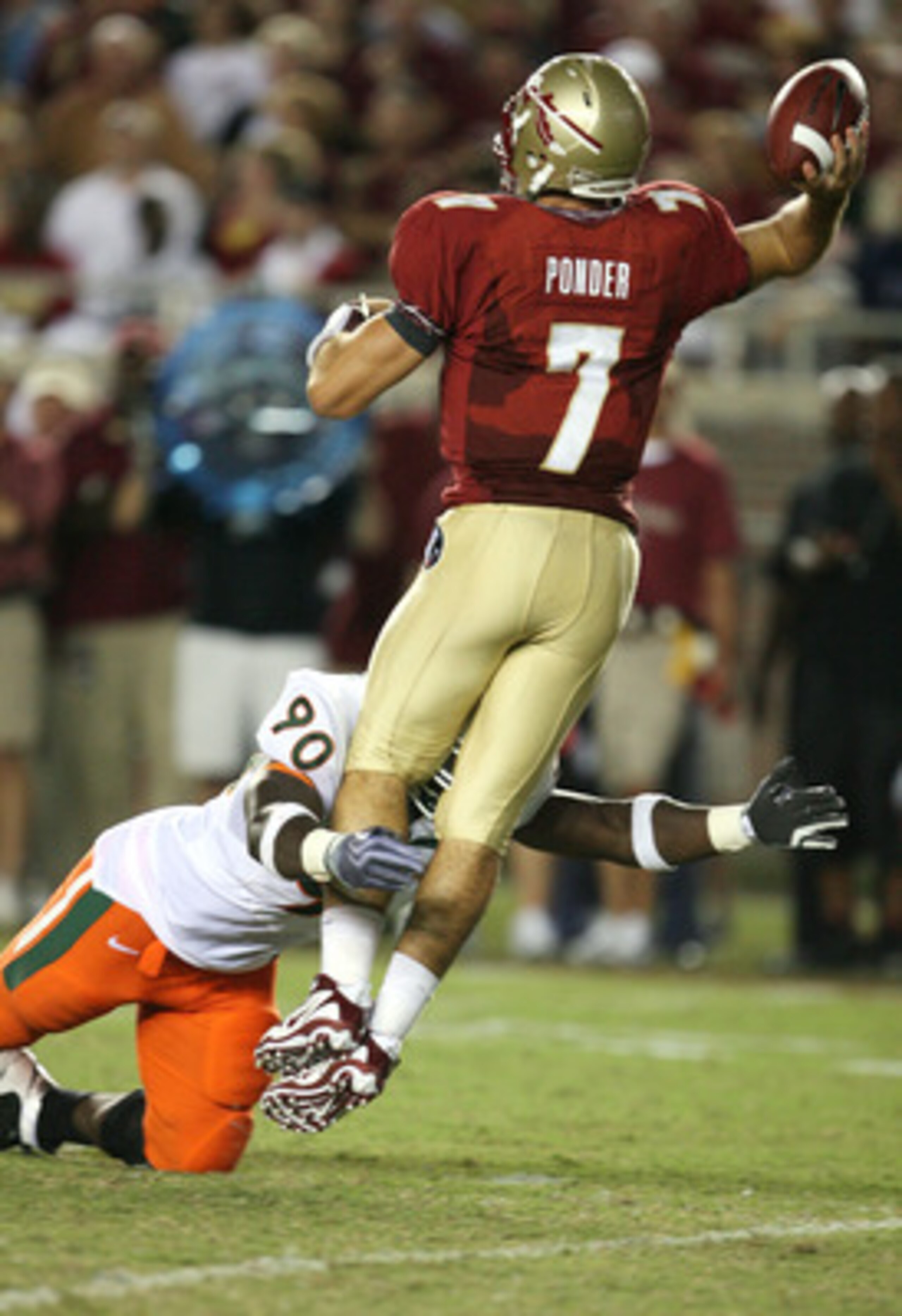TALLAHASSEE, FL - SEPTEMBER 07:  Quarterback Christian Ponder #7 of the Florida State Seminoles throws a pass as he is hit by defensive lineman Steven Wesley #90 of the Miami Hurricanes at Doak Campbell Stadium on September 7, 2009 in Tallahassee, Florida
