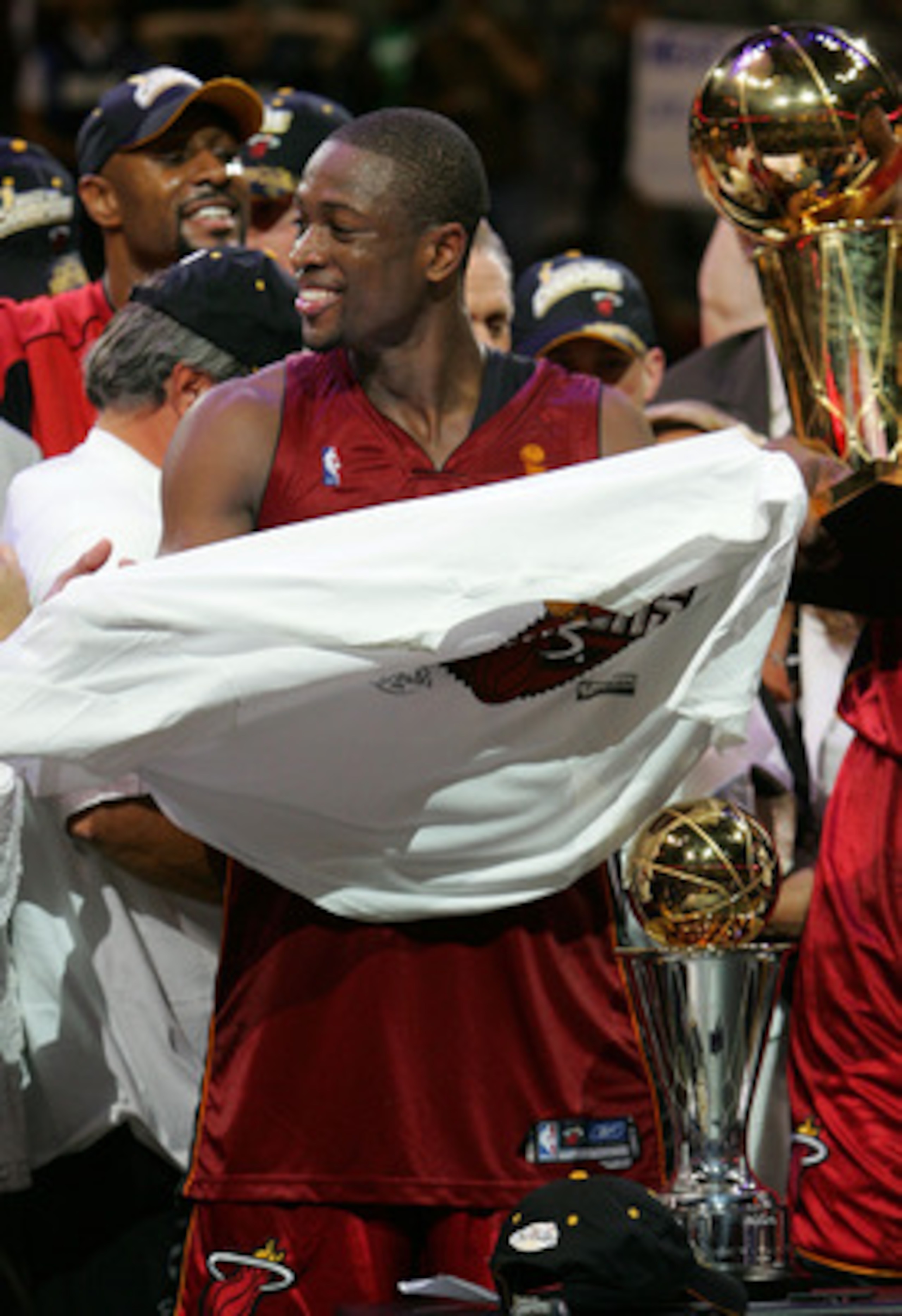 DALLAS - JUNE 20: Dwyane Wade #3 of the Miami Heat puts on the championship t-shirt after game six of the 2006 NBA Finals on June 20, 2006 at American Airlines Center in Dallas, Texas. The Heat defeated the Mavericks 95-92 to win the NBA title. NOTE TO DALLAS - JUNE 20: Dwyane Wade #3 of the Miami Heat puts on the championship t-shirt after game six of the 2006 NBA Finals on June 20, 2006 at American Airlines Center in Dallas, Texas. The Heat defeated the Mavericks 95-92 to win the NBA title. NOTE TO