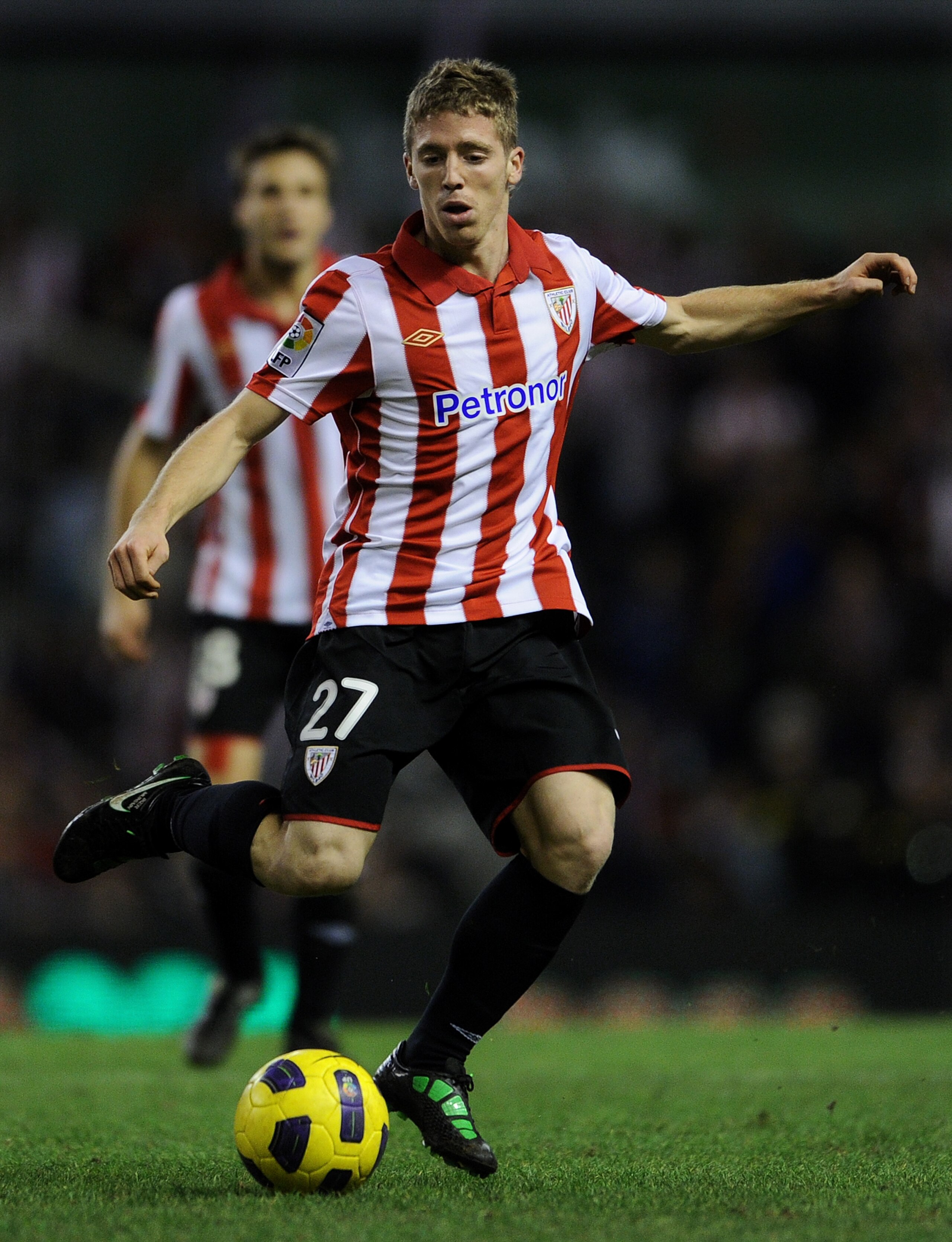 BILBAO, SPAIN - JANUARY 05: Iker Muniain of Athletic Bilbao strikes the ball during the round of last 16 Copa del Rey second leg match between Athletic Bilbao and FC Barcelona at Estadio de San Mames on January 5, 2011 in Bilbao, Spain. The match ended i BILBAO, SPAIN - JANUARY 05: Iker Muniain of Athletic Bilbao strikes the ball during the round of last 16 Copa del Rey second leg match between Athletic Bilbao and FC Barcelona at Estadio de San Mames on January 5, 2011 in Bilbao, Spain. The match ended i