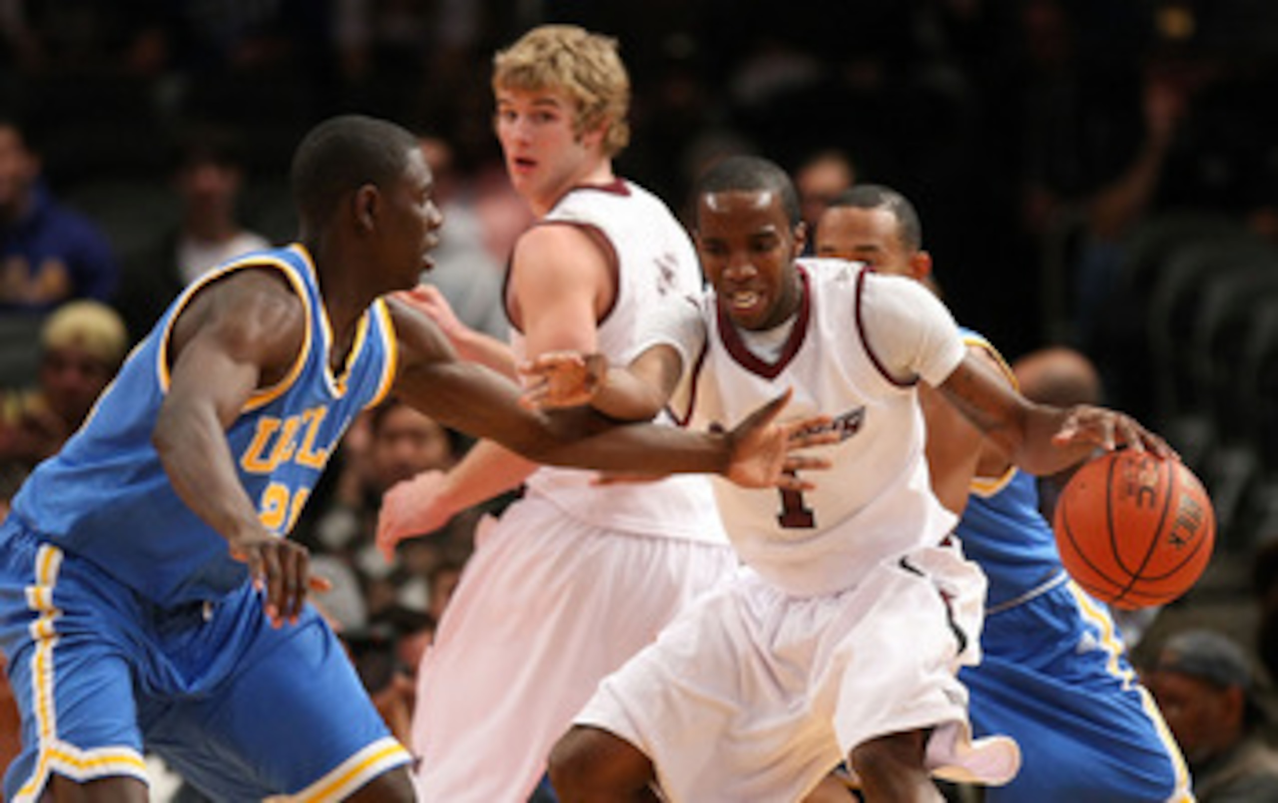 NEW YORK - NOVEMBER 21: Kevin Dillard #1 of the Southern Illinois Salukis dribbles against Jrue Holiday #21 of the UCLA Bruins on November 21, 2008 at Madison Square Garden in New York City.  (Photo by Nick Laham/Getty Images)