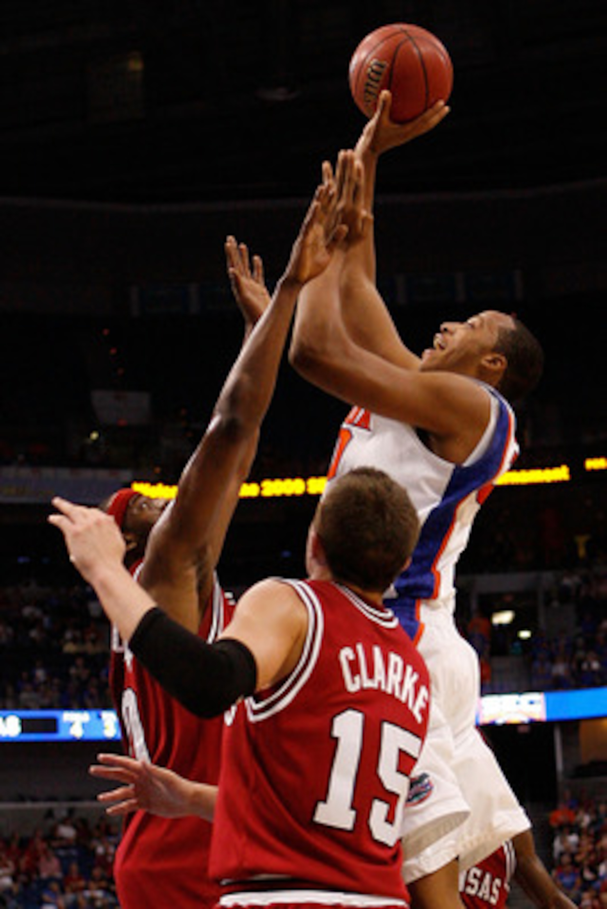 TAMPA, FL - MARCH 12:  Kenny Kadji #30 of the Florida Gators makes a shot over Michael Washington #00 and Rotnei Clarke #15 of the Arkansas Razorbacks  during the first round of the SEC Men's Basketball Tournament on March 12, 2009 at The St. Pete Times F
