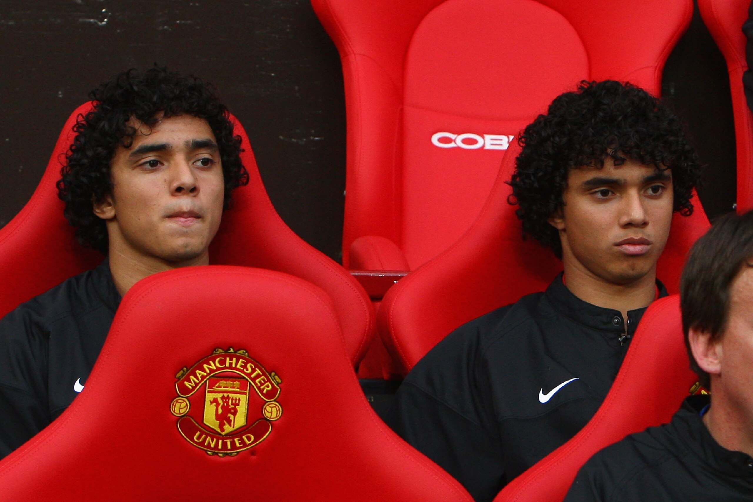 MANCHESTER, UNITED KINGDOM - AUGUST 06: Rafael Da Silva (L) sits on the bench beside his twin brother and team mate Fabio Da Silva of Manchester United prior to the Pre Season Friendly match between Manchester United and Juventus at Old Trafford on Augus MANCHESTER, UNITED KINGDOM - AUGUST 06: Rafael Da Silva (L) sits on the bench beside his twin brother and team mate Fabio Da Silva of Manchester United prior to the Pre Season Friendly match between Manchester United and Juventus at Old Trafford on Augus