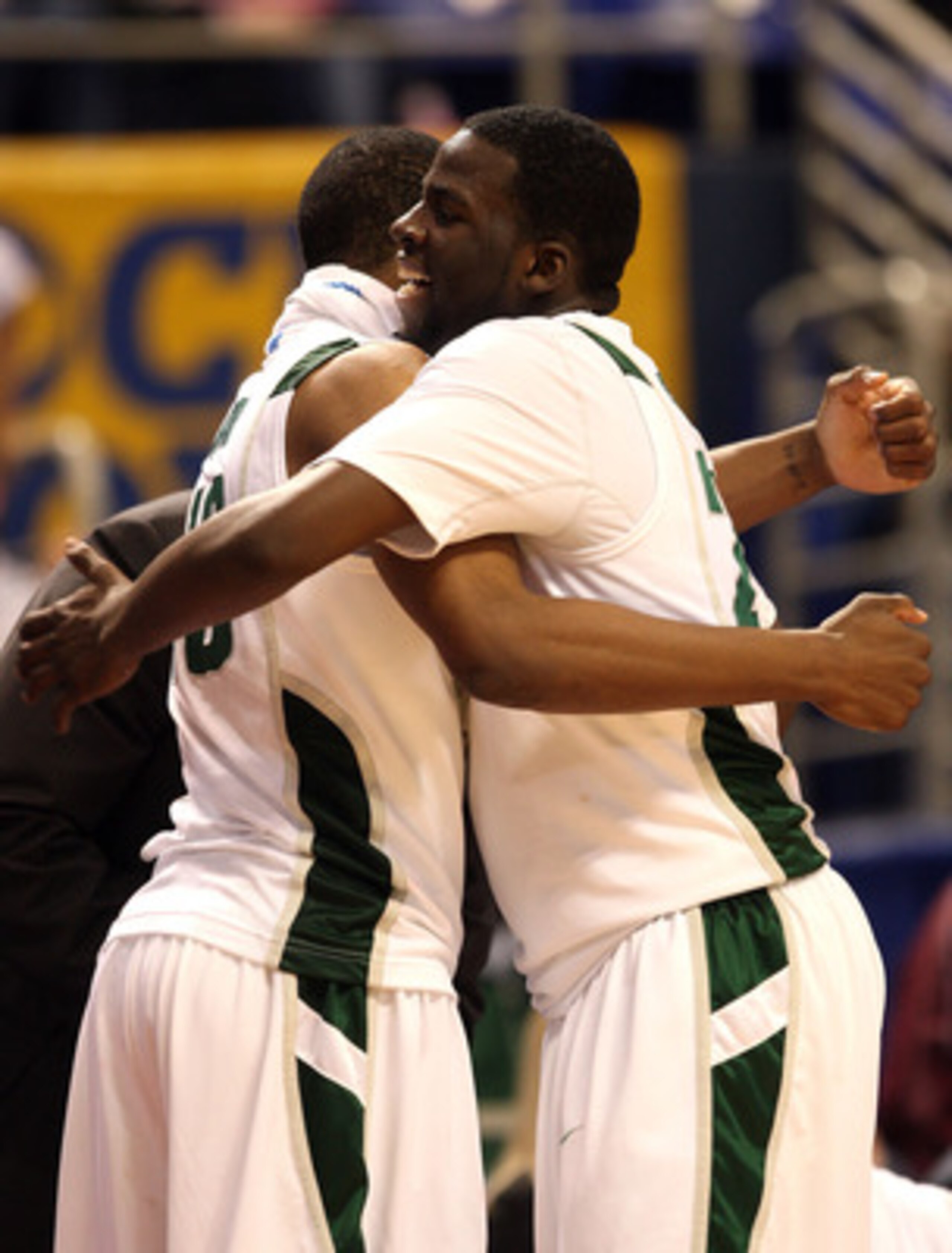MINNEAPOLIS - MARCH 20:  Draymond Green #23 (R) and Delvon Roe #10 of the Michigan State Spartans celebrate at the bench as Green game out of the game late in the second half against the Robert Morris Colonials during the first round of the NCAA Division