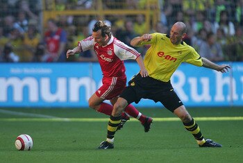 DORTMUND, GERMANY - SEPTEMBER 18:  Jen Jeremies of Munich in action against Jan Koller of Dortmund during The Bundesliga match between Borussia Dortmund and Bayern Munich at The Westfallen Stadium on September 18, 2004 in Dortmund, Germany.  (Photo by Stu
