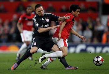 MANCHESTER, ENGLAND - APRIL 07:   Franck Ribery of Bayern Muenchen battles for the ball with Rafael of Manchester United during the UEFA Champions League Quarter Final second leg match between Manchester United and Bayern Muenchen at Old Trafford on April
