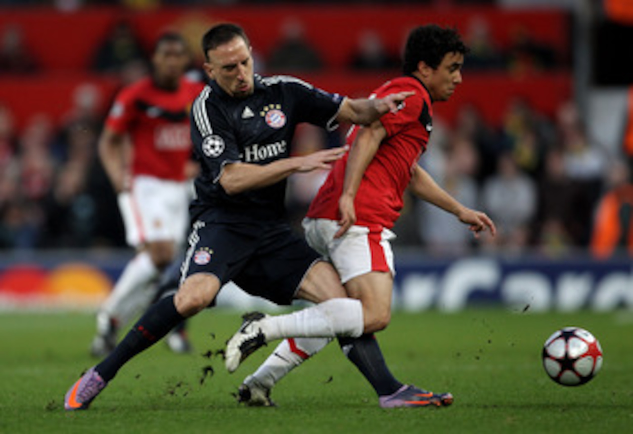 MANCHESTER, ENGLAND - APRIL 07:   Franck Ribery of Bayern Muenchen battles for the ball with Rafael of Manchester United during the UEFA Champions League Quarter Final second leg match between Manchester United and Bayern Muenchen at Old Trafford on April