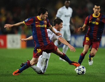 BARCELONA, SPAIN - MAY 03:  Lionel Messi (L) of Barcelona duels for the ball with Xabi Alonso of Real Madrid during the UEFA Champions League Semi Final second leg match between Barcelona and Real Madrid at the Camp Nou stadium on May 3, 2011 in Barcelona