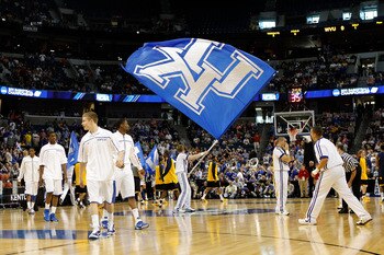 TAMPA, FL - MARCH 19:  A cheerleader from the Kentucky Wildcats waves a giant UK flag as the team warms up prior to playing against the West Virginia Mountaineers during the third round of the 2011 NCAA men's basketball tournament at St. Pete Times Forum
