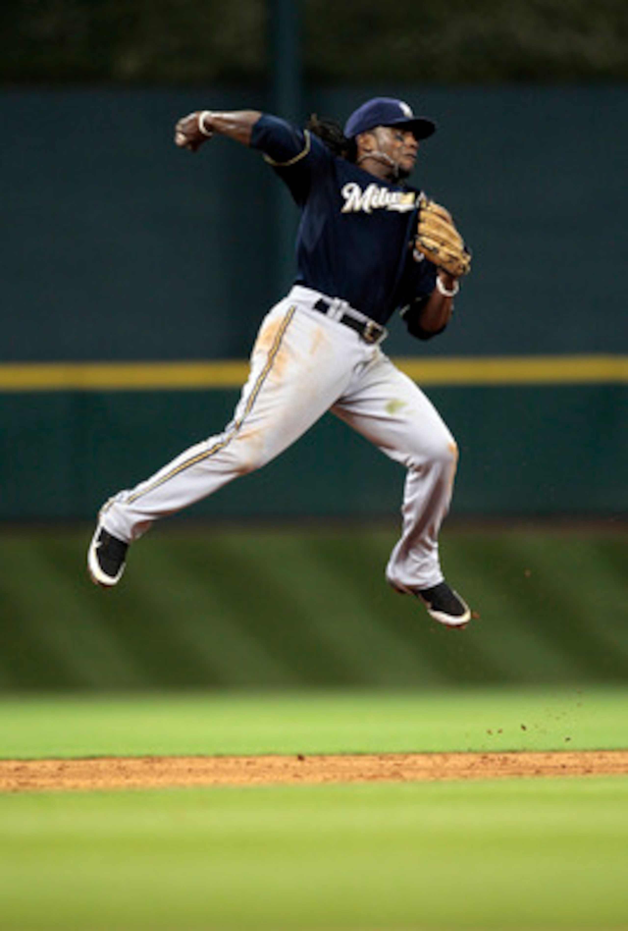 HOUSTON - APRIL 30: Second baseman Rickie Weeks #23 of the Milwaukee Brewers makes a leaping throw to first base against the Houston Astros at Minute Maid Park on April 30, 2011 in Houston, Texas.  (Photo by Bob Levey/Getty Images)