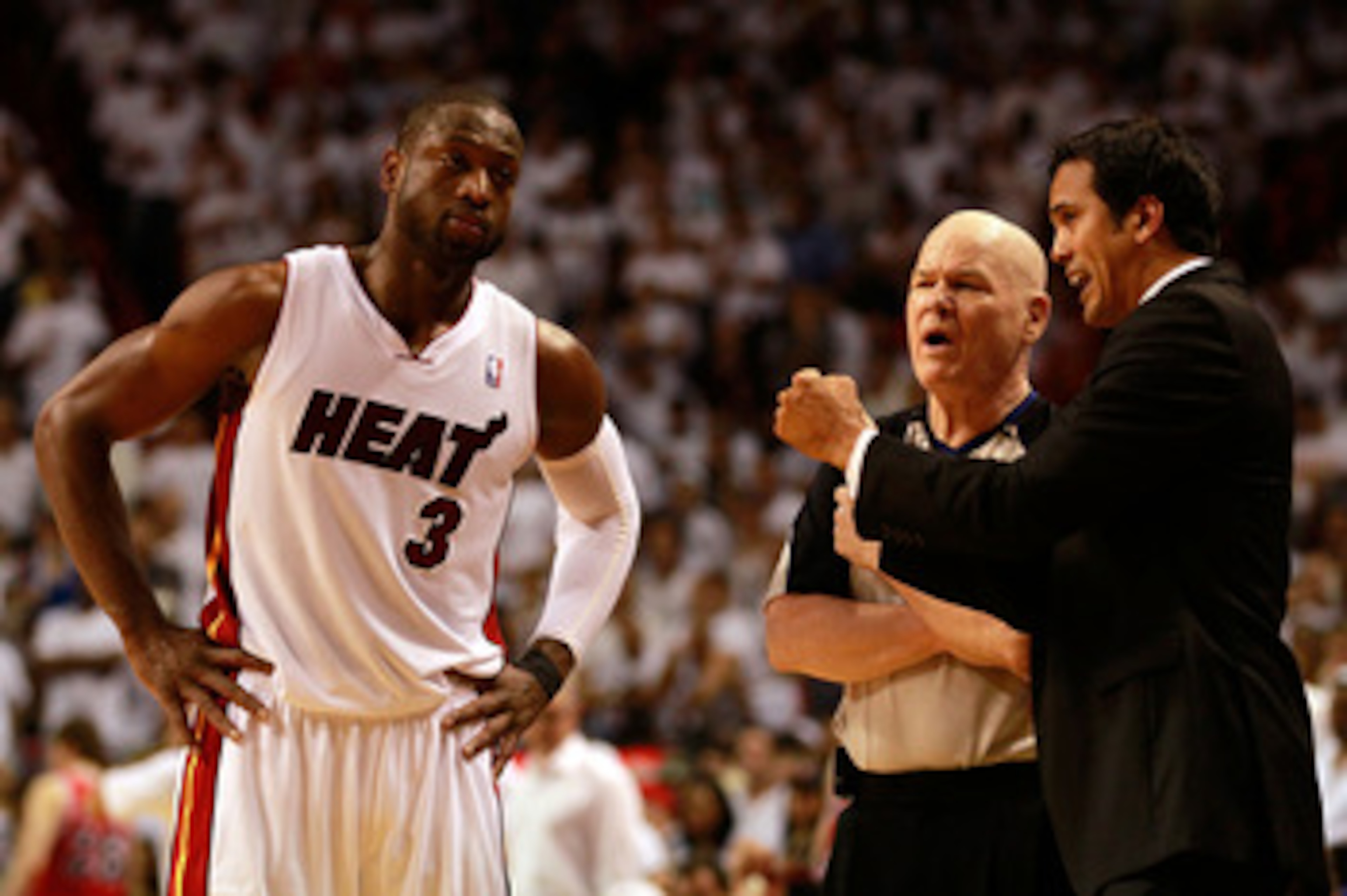 MIAMI, FL - MAY 24: Head coach Erik Spoelstra (R) and Dwyane Wade #3 of the Miami Heat talk with referee Joey Crawford against the Chicago Bulls in Game Four of the Eastern Conference Finals during the 2011 NBA Playoffs on May 24, 2011 at American Airline