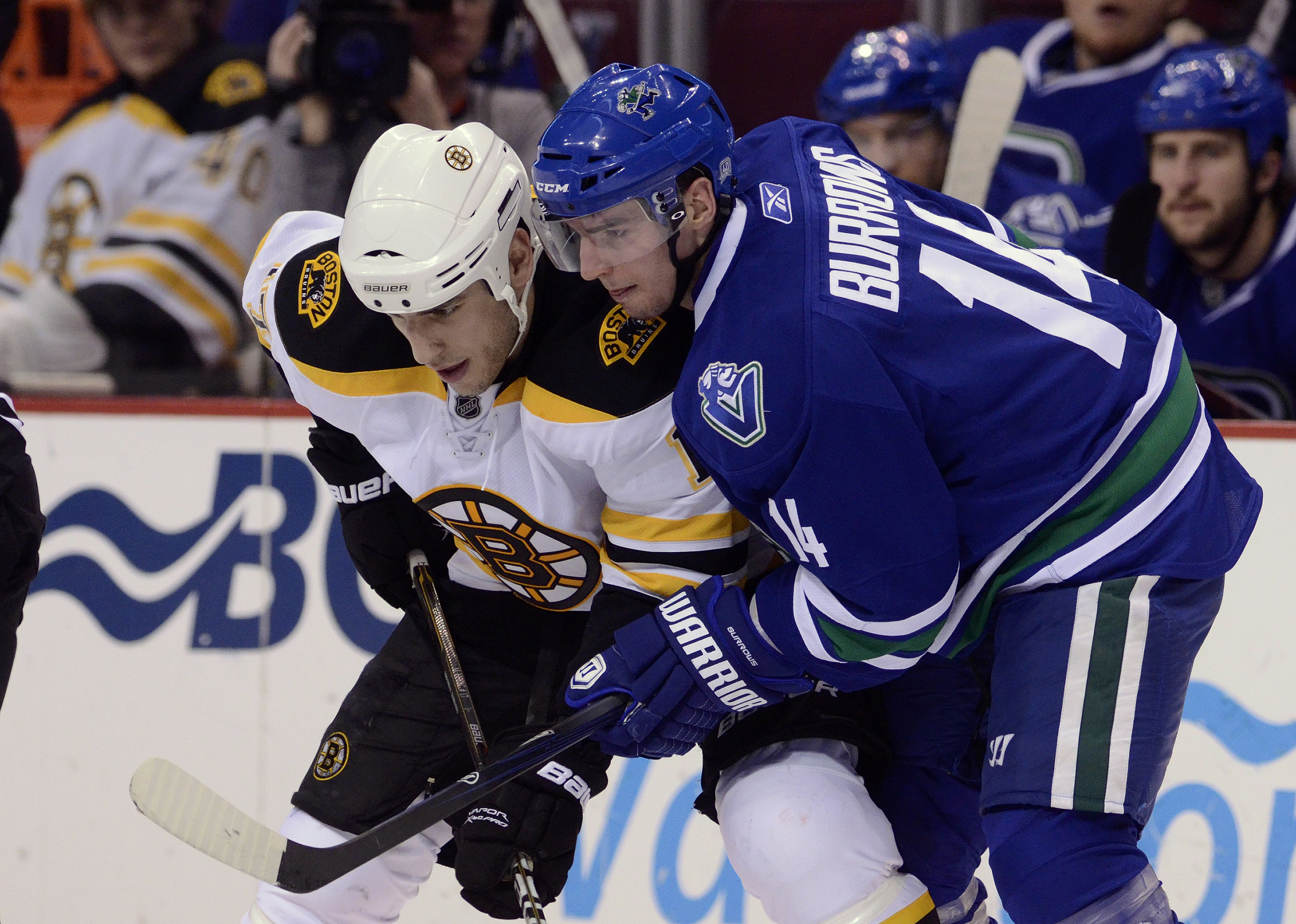 VANCOUVER, CANADA - FEBRUARY 26: Alexandre Burrows #14 of the Vancouver Canucks gets in close to Milan Lucic #17 of the Boston Bruins on a face-off during the third period in NHL action on February 26, 2011 at Rogers Arena in Vancouver, British Columbia,