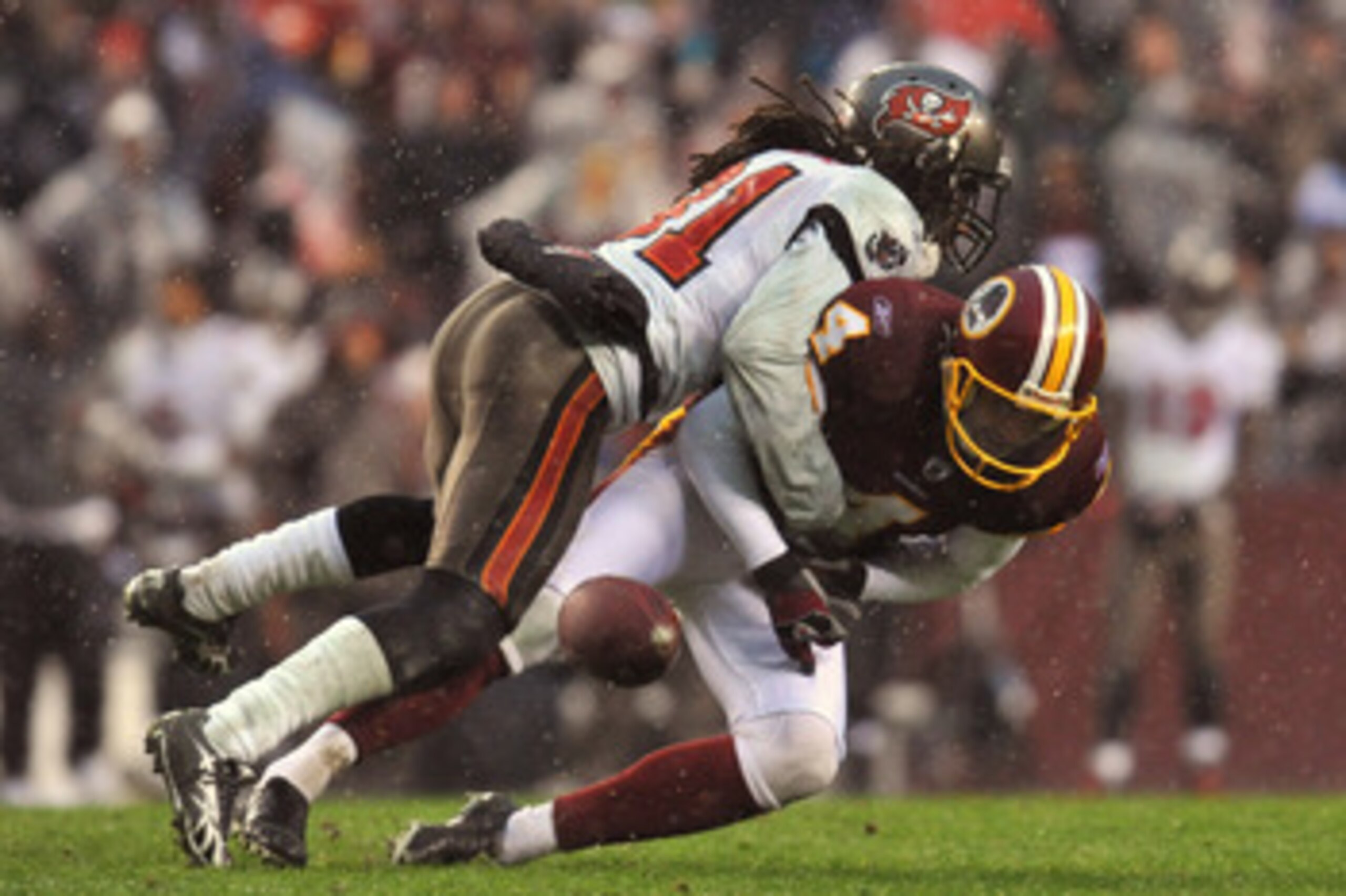 LANDOVER, MD - DECEMBER 12:  E.J. Biggers #31 of the Tampa Bay Buccaneers causes Graham Gano #4 of the Washington Redskins to fumble after a missed snap on an extra point attempt that would have tied the game with seconds remaining in the fourth quarter a