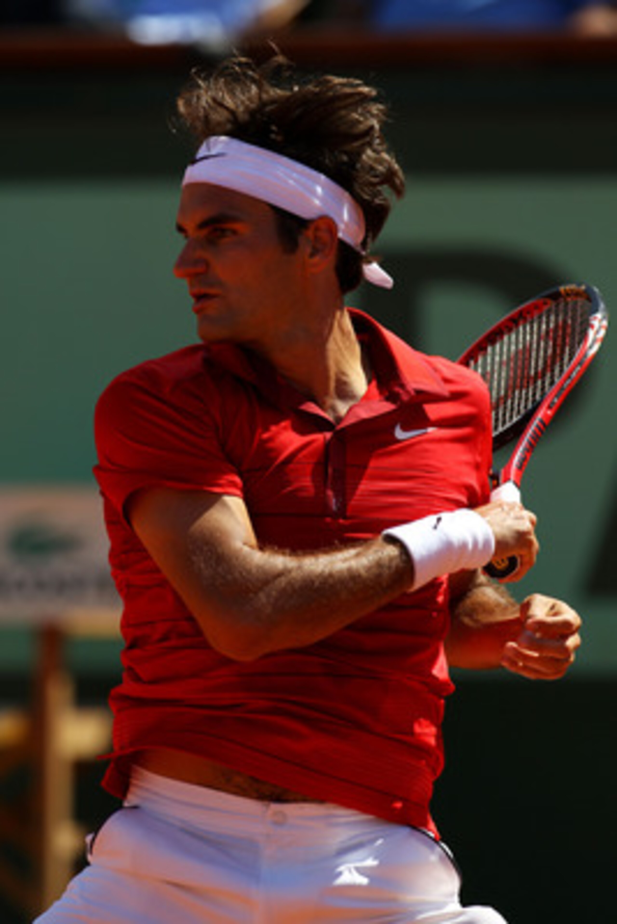 PARIS, FRANCE - MAY 29:  Roger Federer of Switzerland hits a forehand during the men's singles round four match between Stanislas Wawrinka of Switzerland and Roger Federer of Switzerland on day eight of the French Open at Roland Garros on May 29, 2011 in