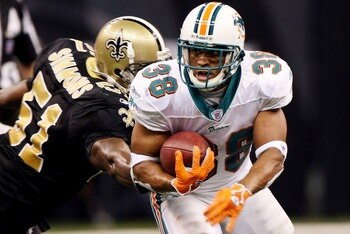 NEW ORLEANS - AUGUST 30:   Patrick Cobbs #38 of the Miami Dolphins avoids a tackle by Brian Simmons #51 of the New Orleans Saints on August 30, 2007 at the Superdome in New Orleans, Louisiana.  (Photo by Chris Graythen/Getty Images)