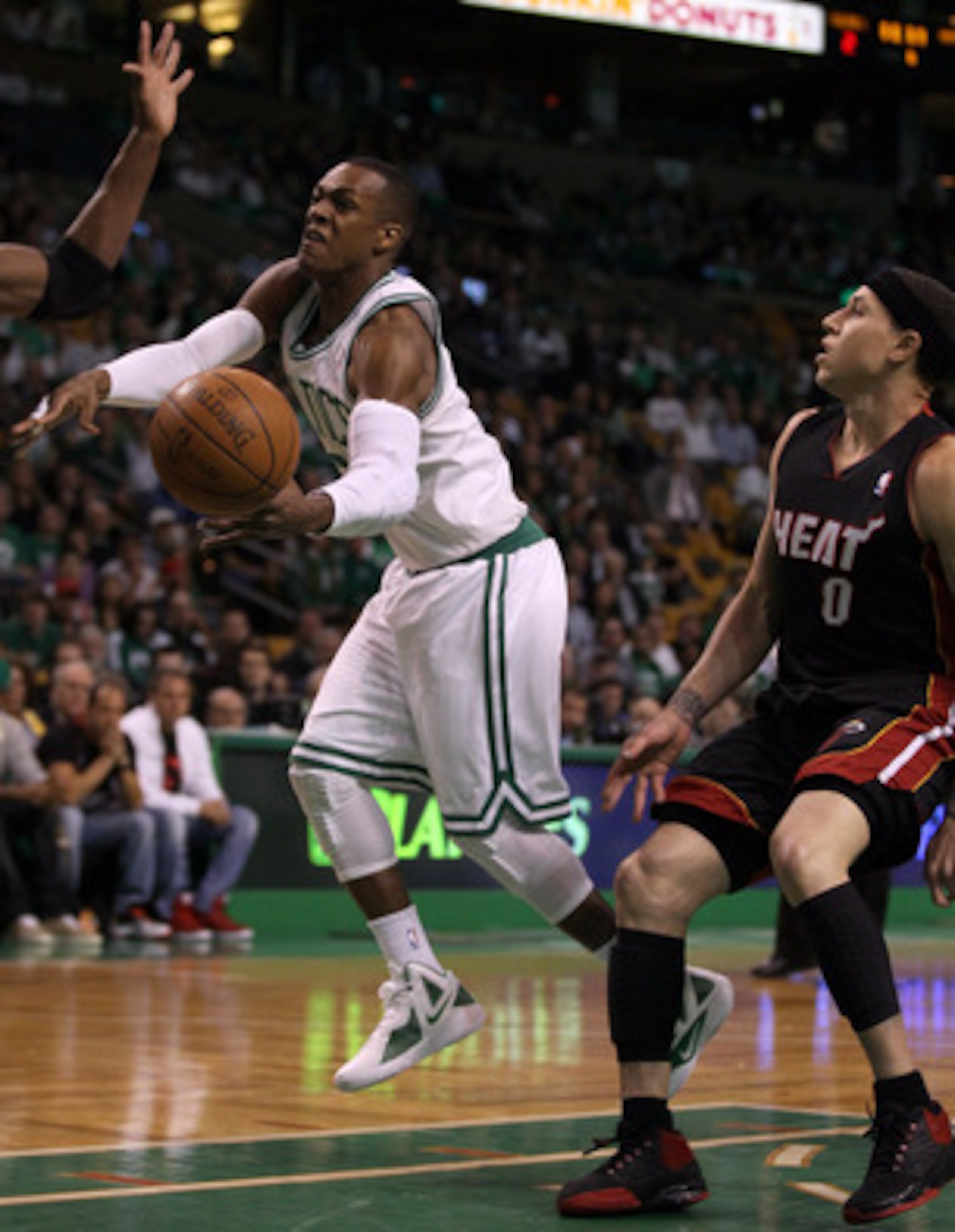 BOSTON, MA - MAY 09: Rajon Rondo #9 of the Boston Celtics is tripped by Mike Bibby #0 of the Miami Heat in Game Four of the Eastern Conference Semifinals in the 2011 NBA Playoffs on May 9, 2011 at the TD Garden in Boston, Massachusetts.  NOTE TO USER: Use