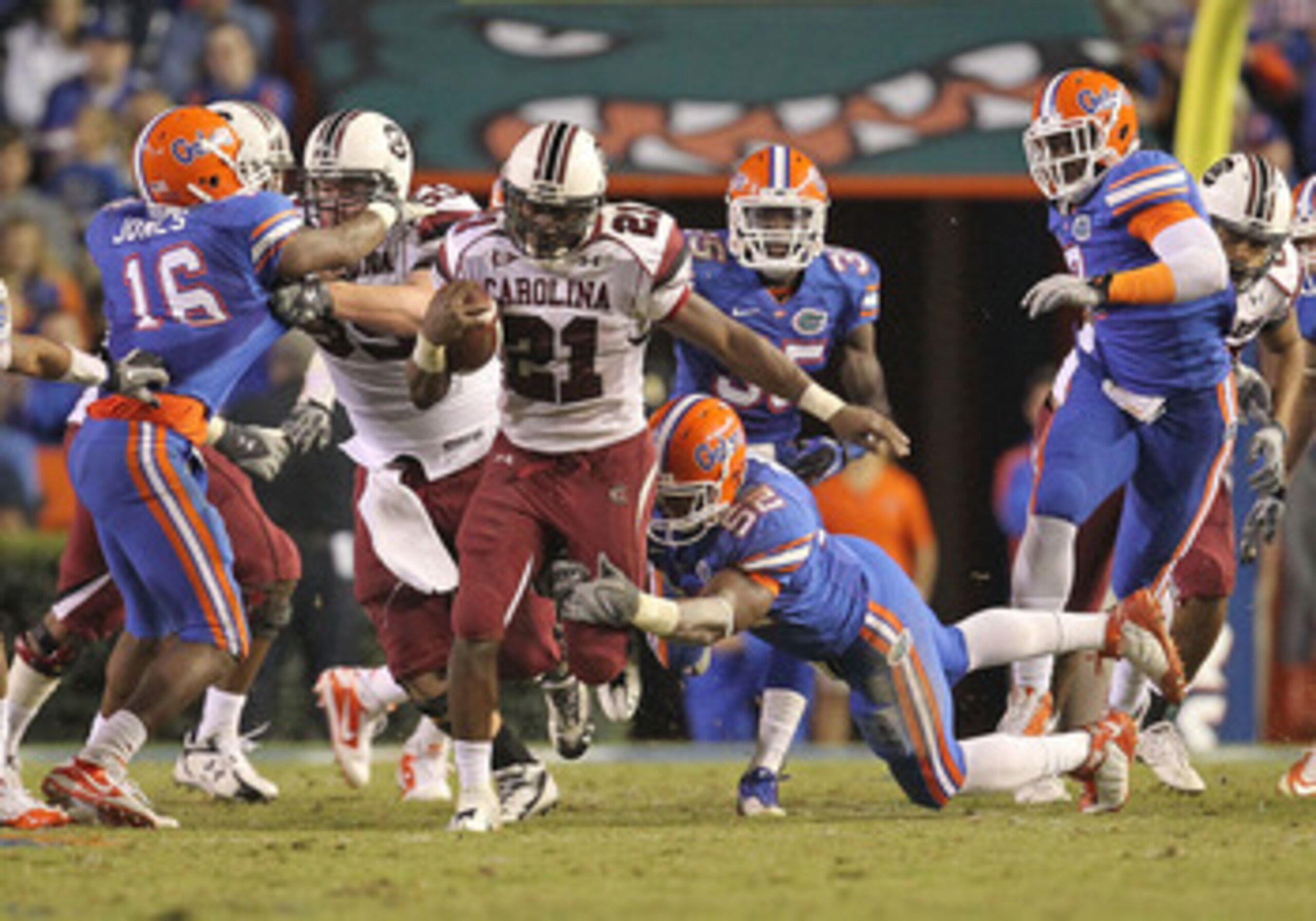 GAINESVILLE, FL - NOVEMBER 13: Marcus Lattimore #21 of the South Carolina Gamecocks rushes against Jonathan Bostic #52 of the Florida Gators at Ben Hill Griffin Stadium on November 13, 2010 in Gainesville, Florida. (Photo by Mike Ehrmann/Getty Images) GAINESVILLE, FL - NOVEMBER 13: Marcus Lattimore #21 of the South Carolina Gamecocks rushes against Jonathan Bostic #52 of the Florida Gators at Ben Hill Griffin Stadium on November 13, 2010 in Gainesville, Florida. (Photo by Mike Ehrmann/Getty Images)
