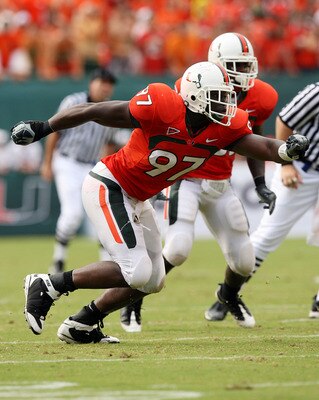 MIAMI - OCTOBER 04:  Defensive lineman Adewale Ojomo #97 of the Miami Hurricanes tries to get to quarterback Christian Ponder #7 of the Florida State Seminoles at Dolphin Stadium on October 4, 2008 in Miami, Florida. Florida State defeated Miami 41-39.  (