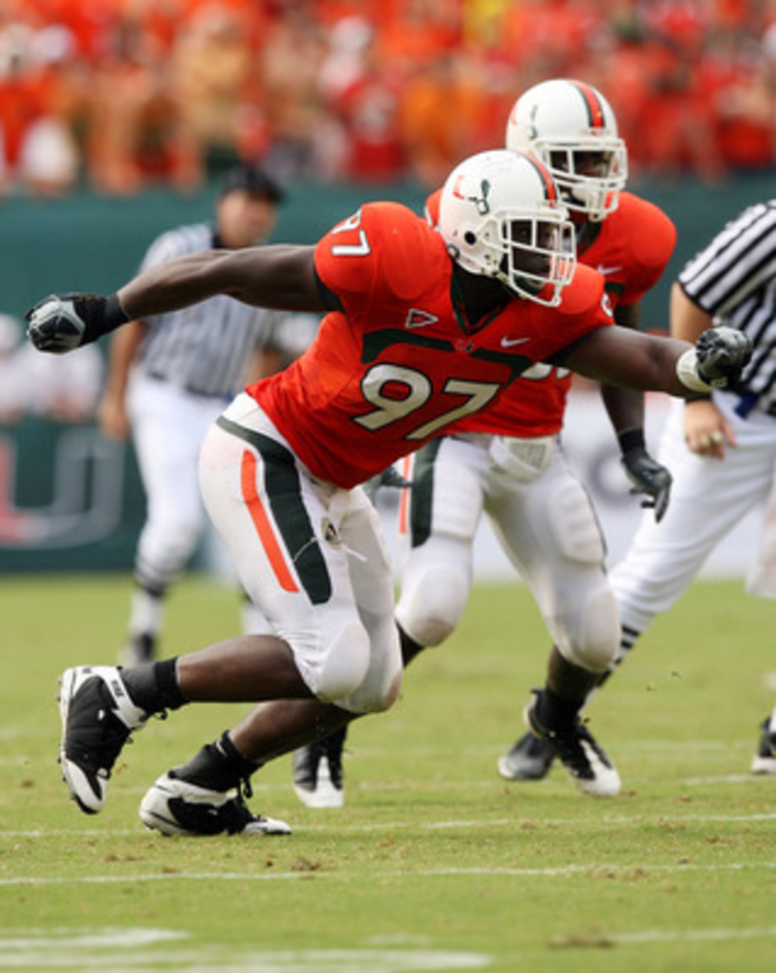 MIAMI - OCTOBER 04:  Defensive lineman Adewale Ojomo #97 of the Miami Hurricanes tries to get to quarterback Christian Ponder #7 of the Florida State Seminoles at Dolphin Stadium on October 4, 2008 in Miami, Florida. Florida State defeated Miami 41-39.  (