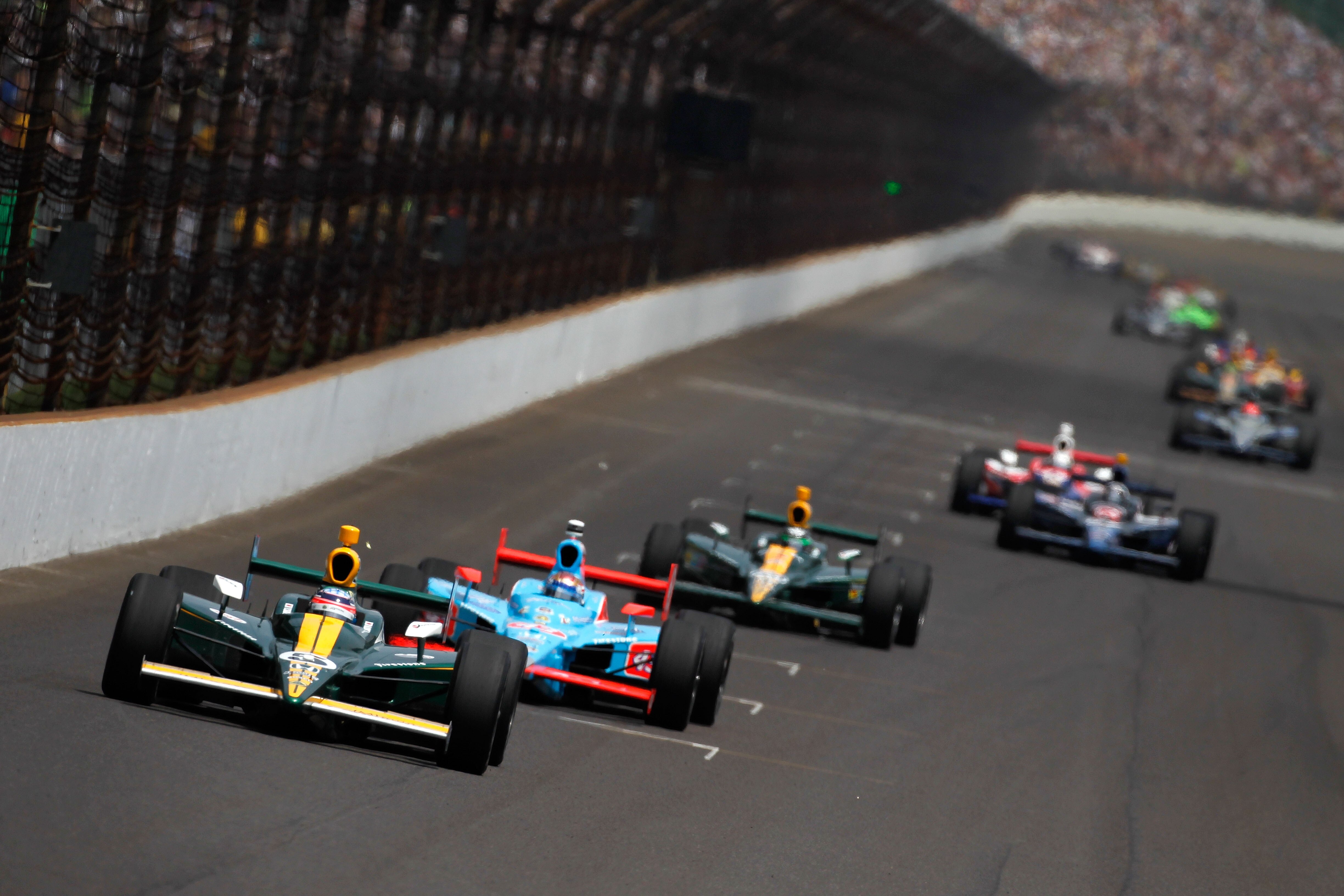 INDIANAPOLIS, IN - MAY 29:  Takuma Sato of Japan, driver of the #5 Lotus KV Racing Technologies Dallara Honda, leads a line of cars during the IZOD IndyCar Series Indianapolis 500 Mile Race at Indianapolis Motor Speedway on May 29, 2011 in Indianapolis, I