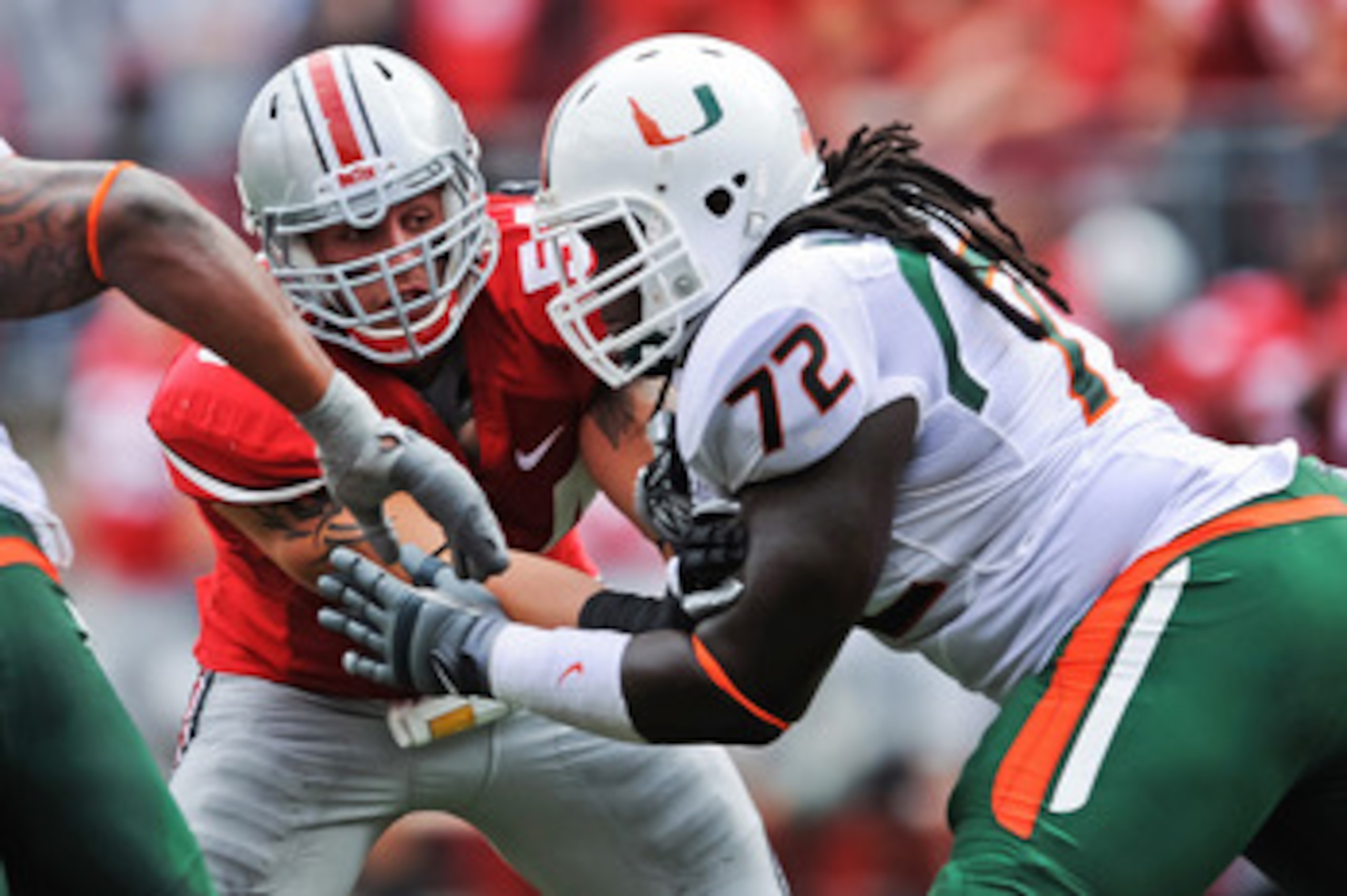 COLUMBUS, OH - SEPTEMBER 11:  John Simon #54 of the Ohio State Buckeyes is blocked by Brandon Washington #72 of the Miami Hurricanes at Ohio Stadium on September 11, 2010 in Columbus, Ohio.  (Photo by Jamie Sabau/Getty Images)