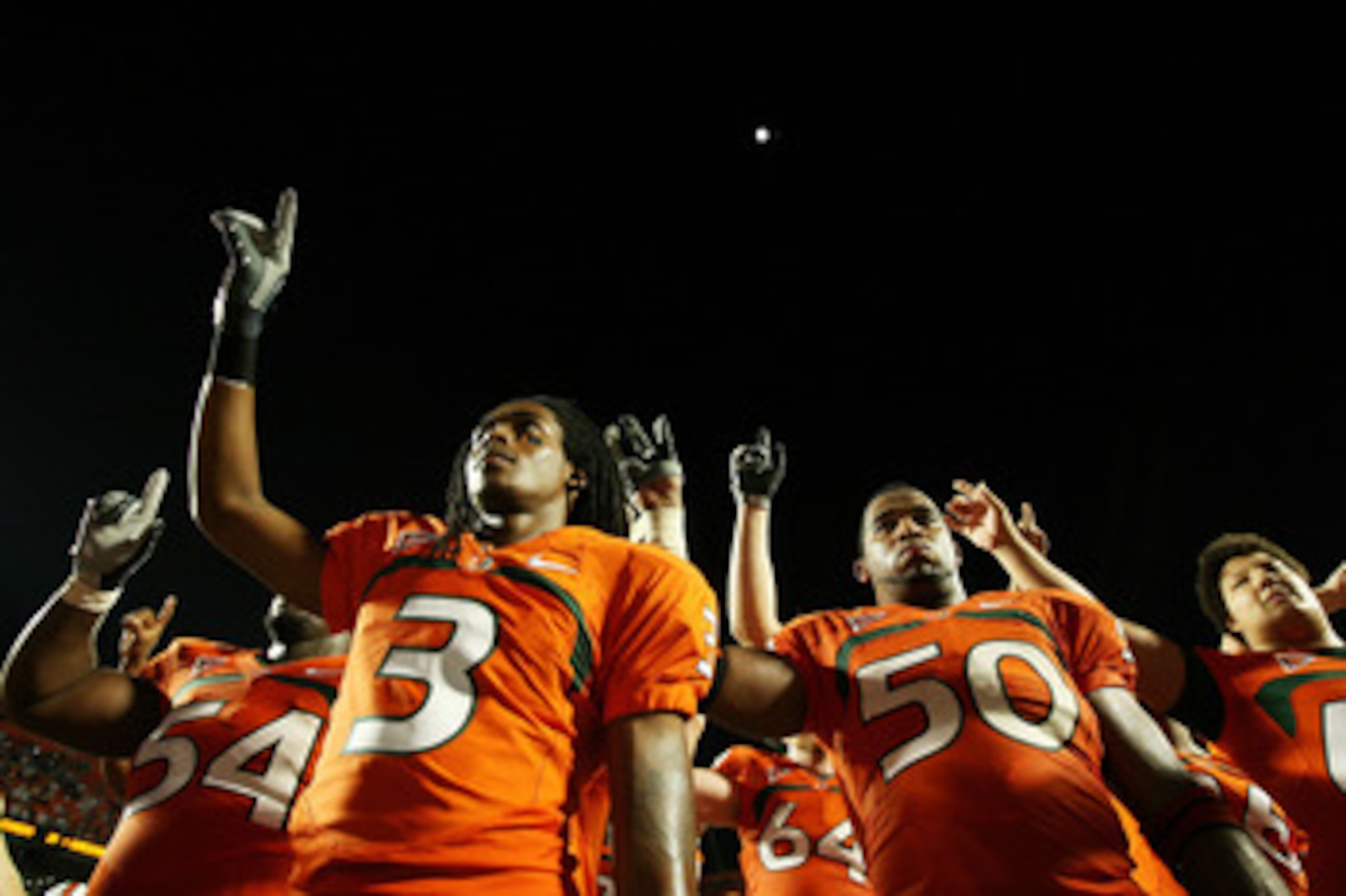 FORT LAUDERDALE, FL - OCTOBER 03: Wide receiver Travis Benjamin #3 and linebacker Darryl Sharpton #50 of the Miami Hurricanes celebrate after defeating the Oklahoma Sooners at Land Shark Stadium on October 3, 2009 in Fort Lauderdale, Florida. Miami defeat